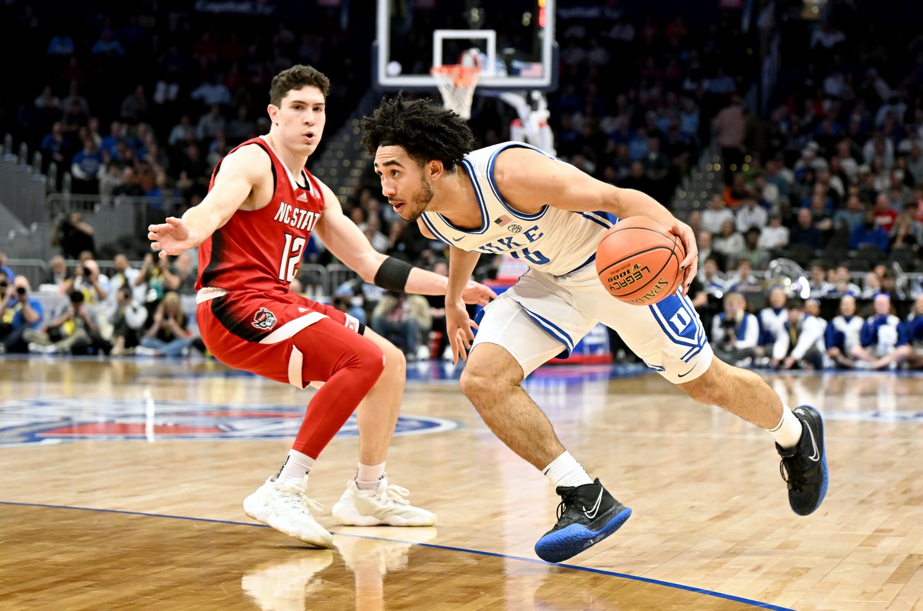 WASHINGTON, DC - MARCH 14: Jared McCain #0 of the Duke Blue Devils handles the ball in the first half against Michael O'Connell #12 of the North Carolina State Wolfpack in the Quarterfinals of the ACC Men's Basketball Tournament  at Capital One Arena on March 14, 2024 in Washington, DC. (Photo by Greg Fiume/Getty Images)