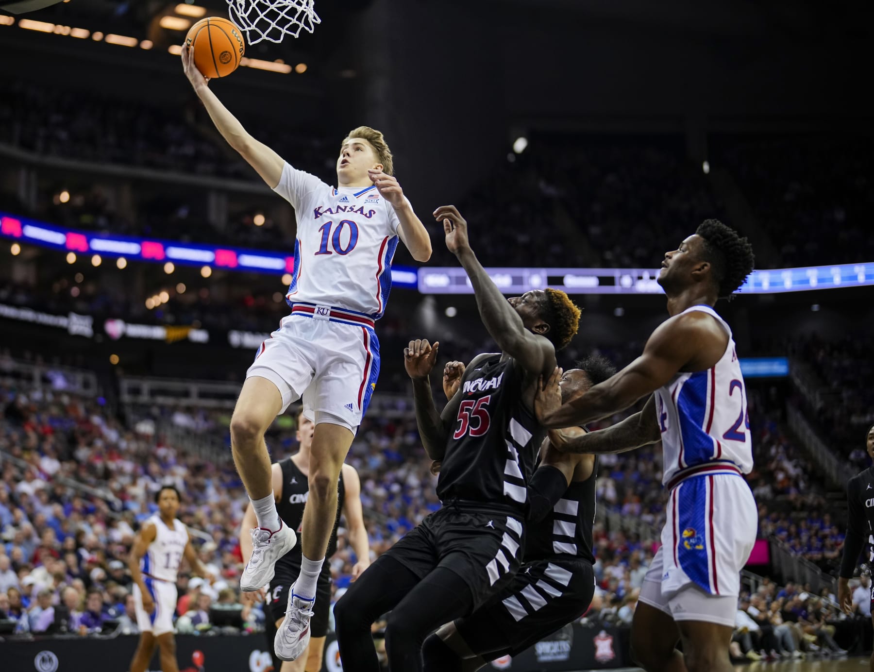 KANSAS CITY, MISSOURI - MARCH 13: Johnny Furphy #10 of the Kansas Jayhawks shoots against the Cincinnati Bearcats during the first half in the second round of the Big 12 Men's Basketball Tournament at T-Mobile Center on March 13, 2024 in Kansas City, Missouri.  (Photo by Jay Biggerstaff/Getty Images)