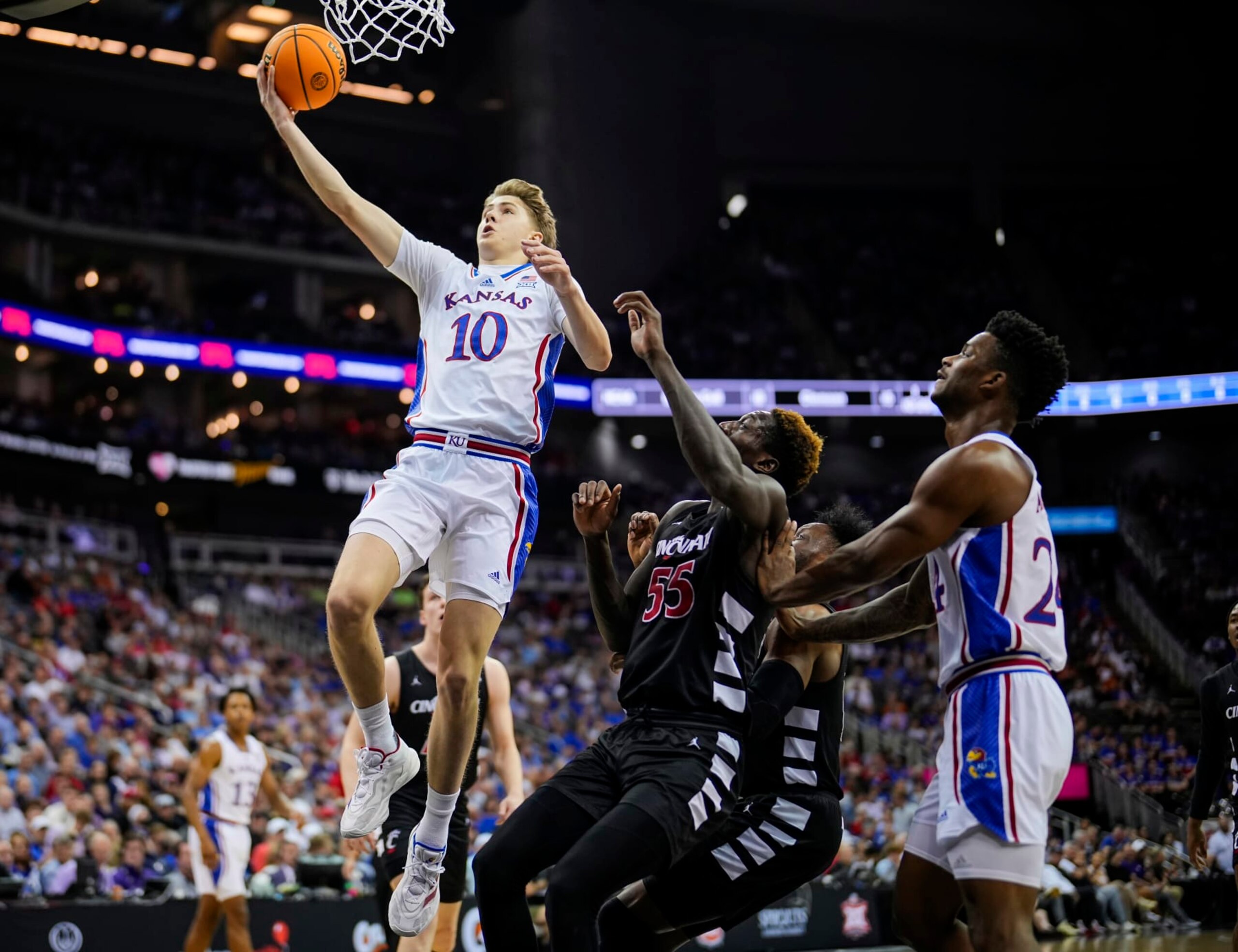 KANSAS CITY, MISSOURI - MARCH 13: Johnny Furphy #10 of the Kansas Jayhawks shoots against the Cincinnati Bearcats during the first half in the second round of the Big 12 Men's Basketball Tournament at T-Mobile Center on March 13, 2024 in Kansas City, Missouri. (Photo by Jay Biggerstaff/Getty Images) KANSAS CITY, MISSOURI - MARCH 13: Johnny Furphy #10 of the Kansas Jayhawks shoots against the Cincinnati Bearcats during the first half in the second round of the Big 12 Men's Basketball Tournament at T-Mobile Center on March 13, 2024 in Kansas City, Missouri. (Photo by Jay Biggerstaff/Getty Images)
