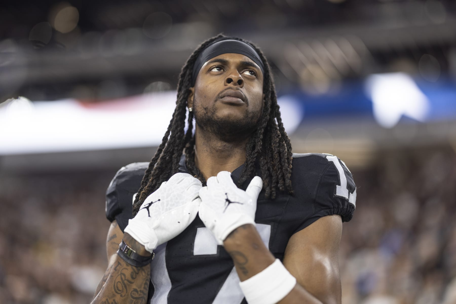 LAS VEGAS, NEVADA - DECEMBER 14: Davante Adams #17 of the Las Vegas Raiders looks on during the national anthem prior to an NFL football game between the Las Vegas Raiders and the Los Angeles Chargers at Allegiant Stadium on December 14, 2023 in Las Vegas, Nevada. (Photo by Michael Owens/Getty Images)