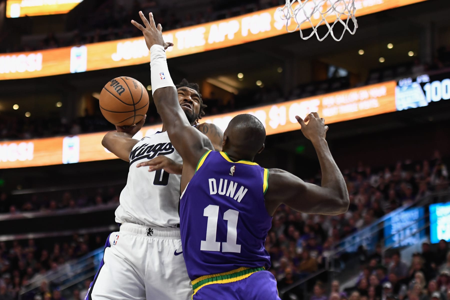 SALT LAKE CITY, UTAH - OCTOBER 25: Malik Monk #0 of the Sacramento Kings dunks over Kris Dunn #11 of the Utah Jazz during the second half of a game at Delta Center on October 25, 2023 in Salt Lake City, Utah. NOTE TO USER: User expressly acknowledges and agrees that, by downloading and or using this photograph, User is consenting to the terms and conditions of the Getty Images License Agreement. (Photo by Alex Goodlett/Getty Images)