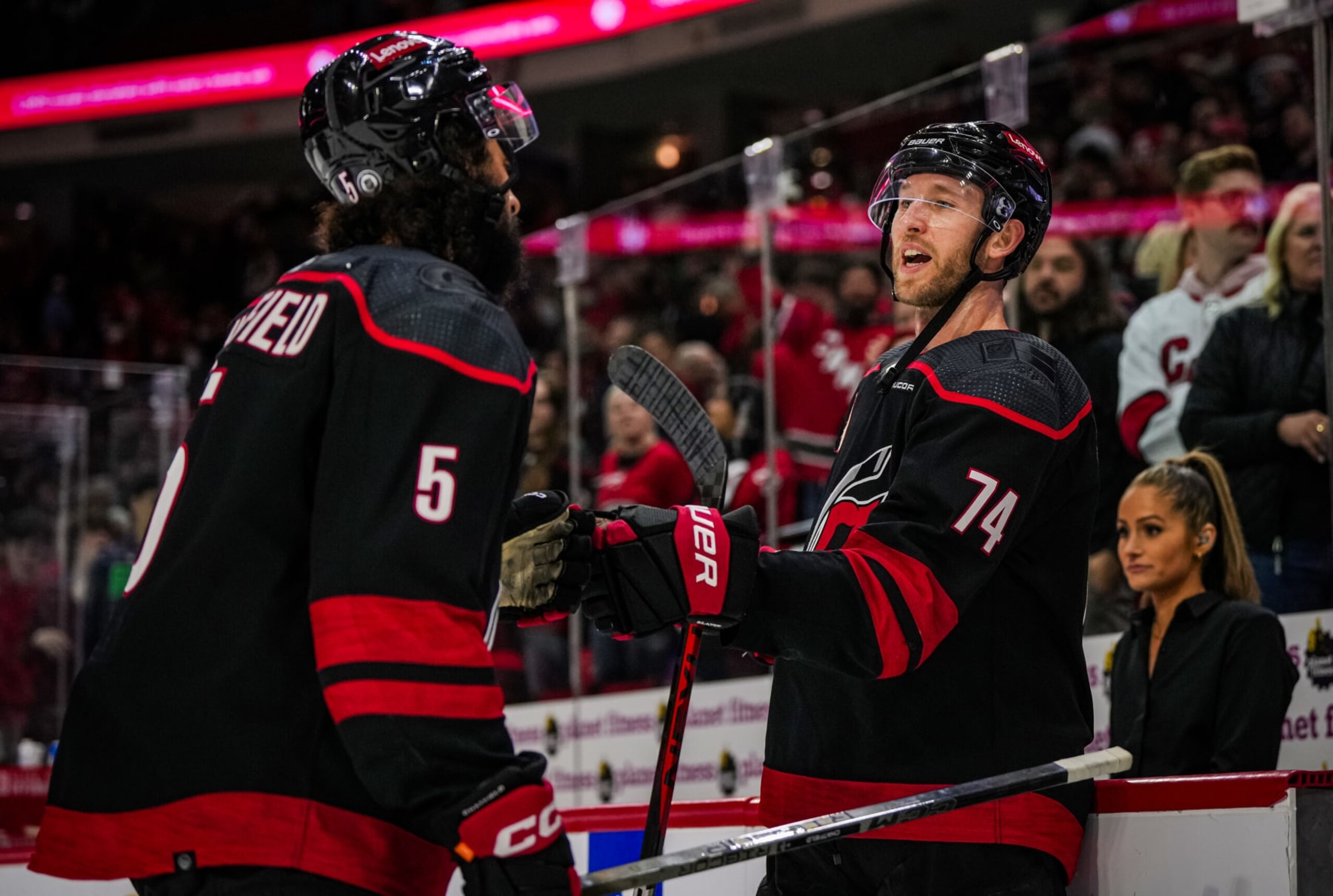 RALEIGH, NORTH CAROLINA - FEBRUARY 08: Jaccob Slavin #74 and Jalen Chatfield #5 of the Carolina Hurricanes react after a 5-2 victory against the Colorado Avalanche at PNC Arena on February 08, 2024 in Raleigh, North Carolina. (Photo by Josh Lavallee/NHLI via Getty Images)