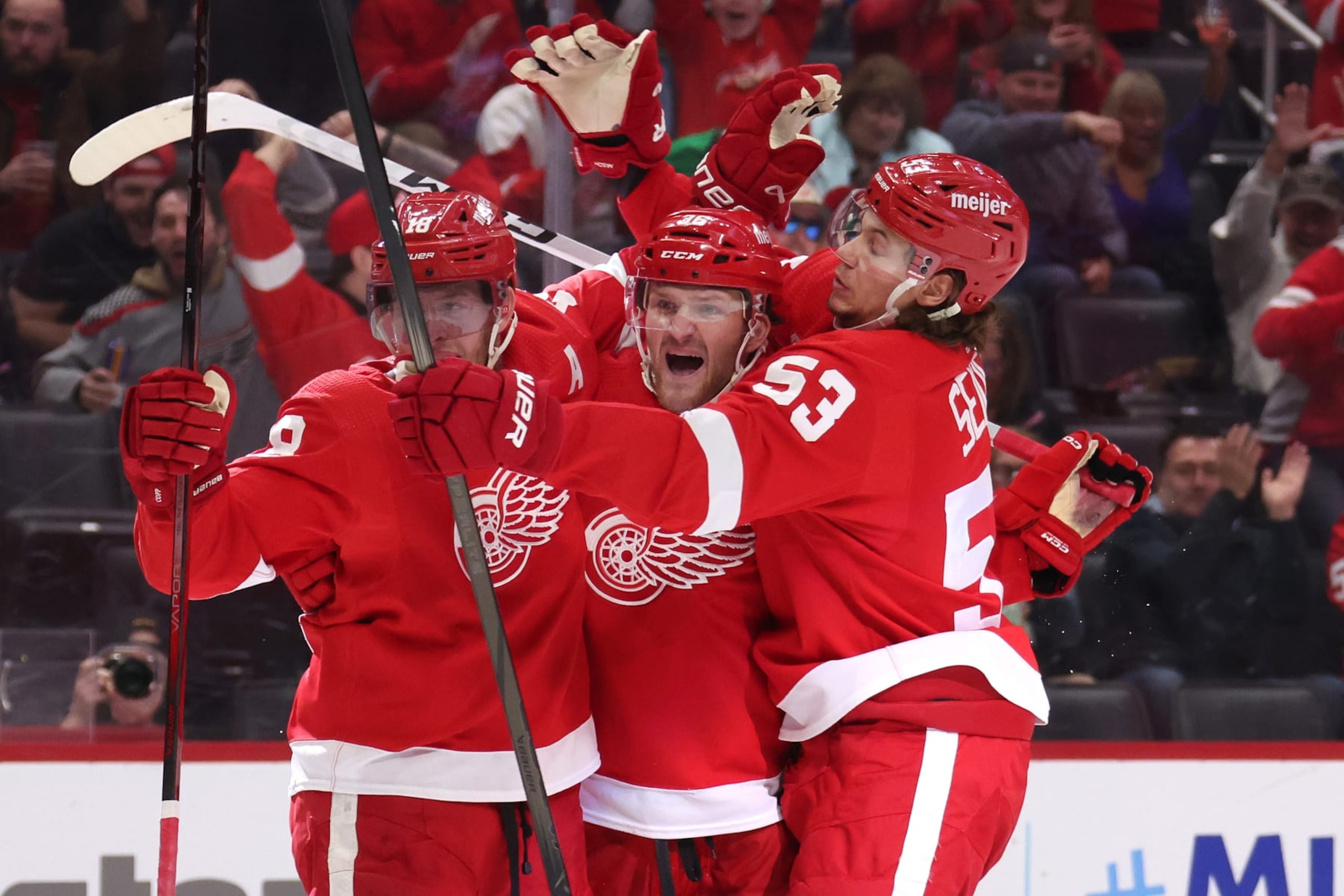 DETROIT, MICHIGAN - MARCH 16: Christian Fischer #36 of the Detroit Red Wings celebrates his second period goal against the Buffalo Sabres with Moritz Seider #53 and Andrew Copp #18 at Little Caesars Arena on March 16, 2024 in Detroit, Michigan. (Photo by Gregory Shamus/Getty Images)