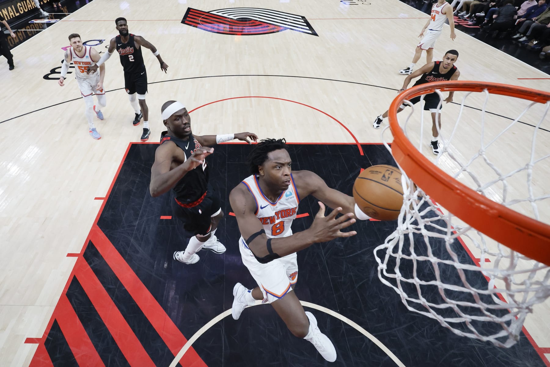 PORTLAND, OREGON - MARCH 14: OG Anunoby #8 of the New York Knicks drives to the basket past Duop Reath #26 (L) of the Portland Trail Blazers during the second half at Moda Center on March 14, 2024 in Portland, Oregon. NOTE TO USER: User expressly acknowledges and agrees that, by downloading and or using this photograph, User is consenting to the terms and conditions of the Getty Images License Agreement.  (Photo by Soobum Im/Getty Images)
