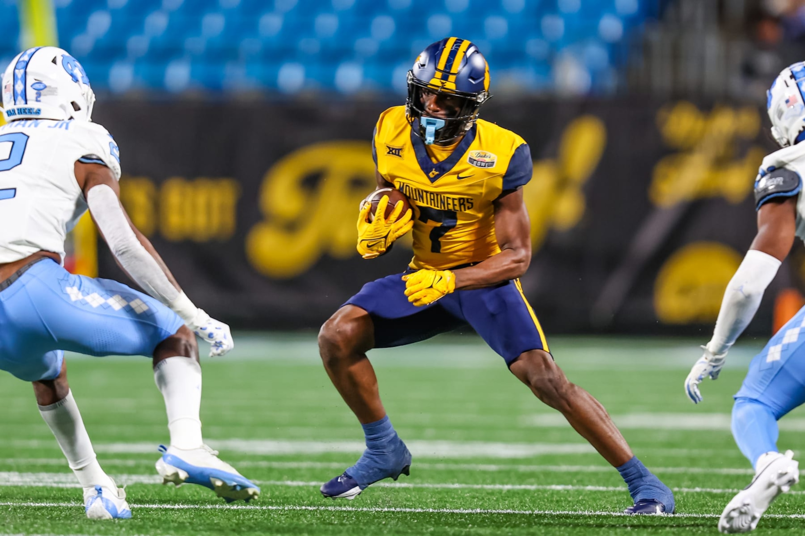CHARLOTTE, NC - DECEMBER 27: Traylon Ray #7 of the West Virginia Mountaineers runs the ball during the Duke's Mayo Bowl against the North Carolina Tar Heels at Bank of America Stadium on December 27, 2023 in Charlotte, NC. (Photo by David Jensen/Icon Sportswire via Getty Images) CHARLOTTE, NC - DECEMBER 27: Traylon Ray #7 of the West Virginia Mountaineers runs the ball during the Duke's Mayo Bowl against the North Carolina Tar Heels at Bank of America Stadium on December 27, 2023 in Charlotte, NC. (Photo by David Jensen/Icon Sportswire via Getty Images)