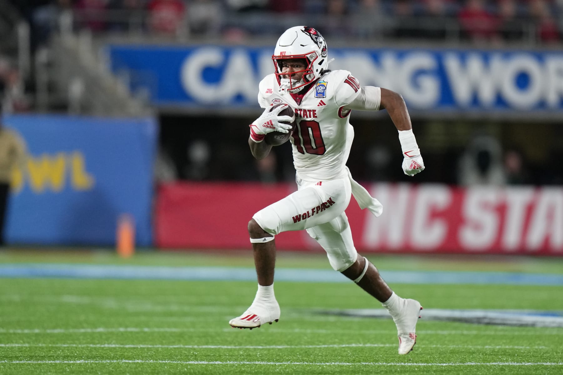 ORLANDO, FL - DECEMBER 28: North Carolina State Wolfpack wide receiver Kevin Concepcion (10) runs for a gain of eight yards in the first half during the Pop-Tarts Bowl between the North Carolina State Wolfpack and the Kansas State Wildcats on Thursday, December 28, 2023 at Camping World Stadium, Orlando, Fla. (Photo by Peter Joneleit/Icon Sportswire via Getty Images)