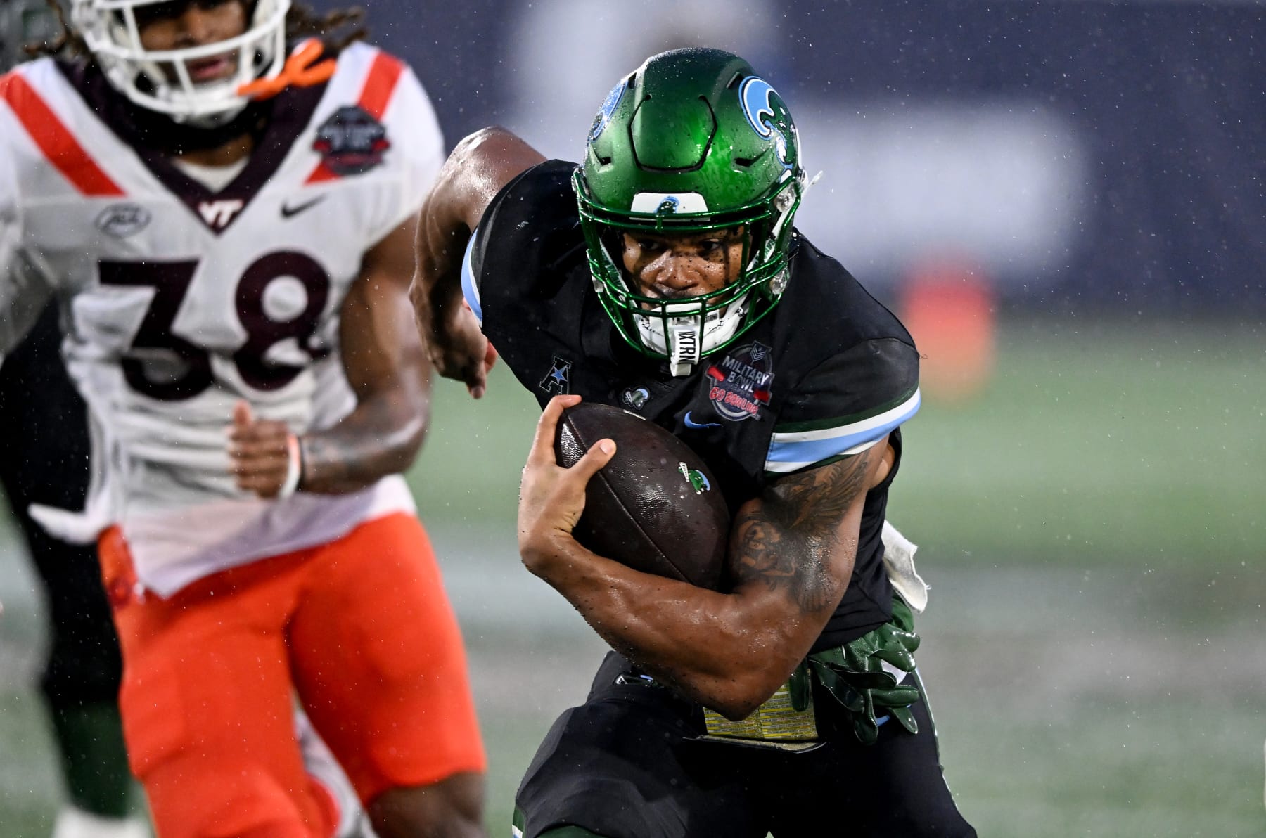 ANNAPOLIS, MARYLAND - DECEMBER 27:  Makhi Hughes #21 of the Tulane Green Wave rushes the ball against the Virginia Tech Hokies during the Military Bowl presented by GoBowling.com  at Navy-Marine Corps Memorial Stadium on December 27, 2023 in Annapolis, Maryland. (Photo by G Fiume/Getty Images)