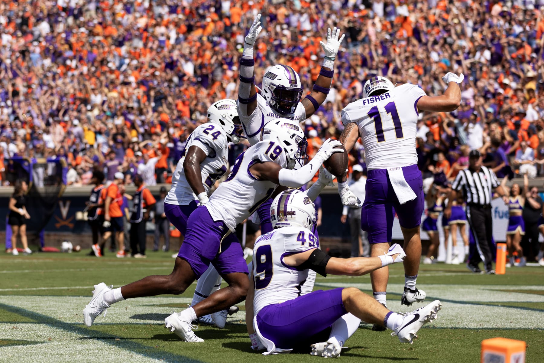 CHARLOTTESVILLE, VIRGINIA - SEPTEMBER 9: D'Angelo Ponds #19 of the James Madison Dukes celebrates recovering a blocked punt for a touchdown in the first half during a game against the Virginia Cavaliers at Scott Stadium on September 9, 2023 in Charlottesville, Virginia. (Photo by Ryan M. Kelly/Getty Images)