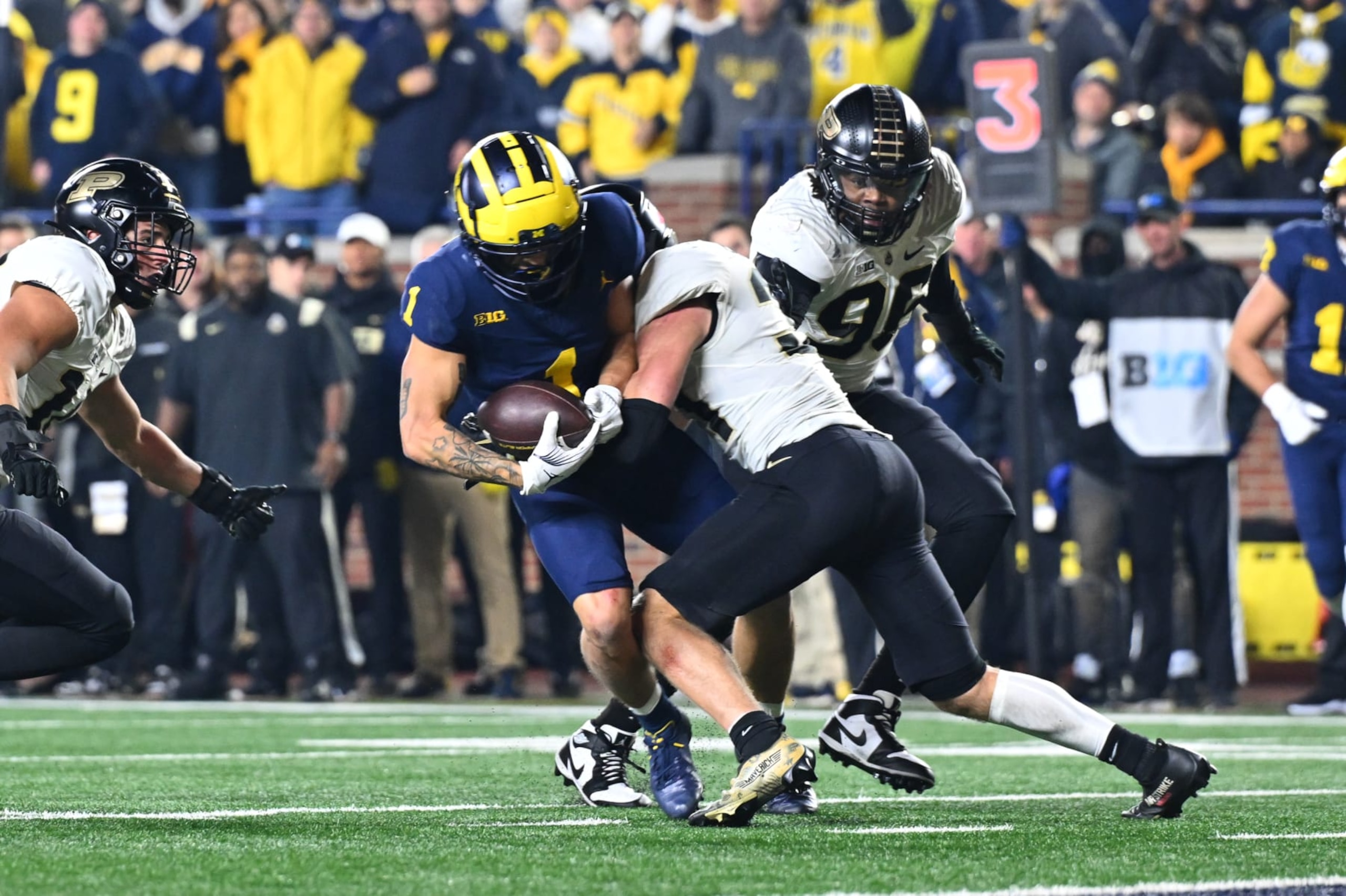 ANN ARBOR, MI - NOVEMBER 04: Michigan Wolverines wide receiver Roman Wilson (1) makes a catch inside the 5 yard line and is immediately tackled by Purdue Boilermakers defensive back Dillon Thieneman (31) during the Michigan Wolverines versus the Purdue Boilermakers on Saturday November 4, 2023 at Michigan Stadium in Ann Arbor, MI. (Photo by Steven King/Icon Sportswire via Getty Images) ANN ARBOR, MI - NOVEMBER 04: Michigan Wolverines wide receiver Roman Wilson (1) makes a catch inside the 5 yard line and is immediately tackled by Purdue Boilermakers defensive back Dillon Thieneman (31) during the Michigan Wolverines versus the Purdue Boilermakers on Saturday November 4, 2023 at Michigan Stadium in Ann Arbor, MI. (Photo by Steven King/Icon Sportswire via Getty Images)