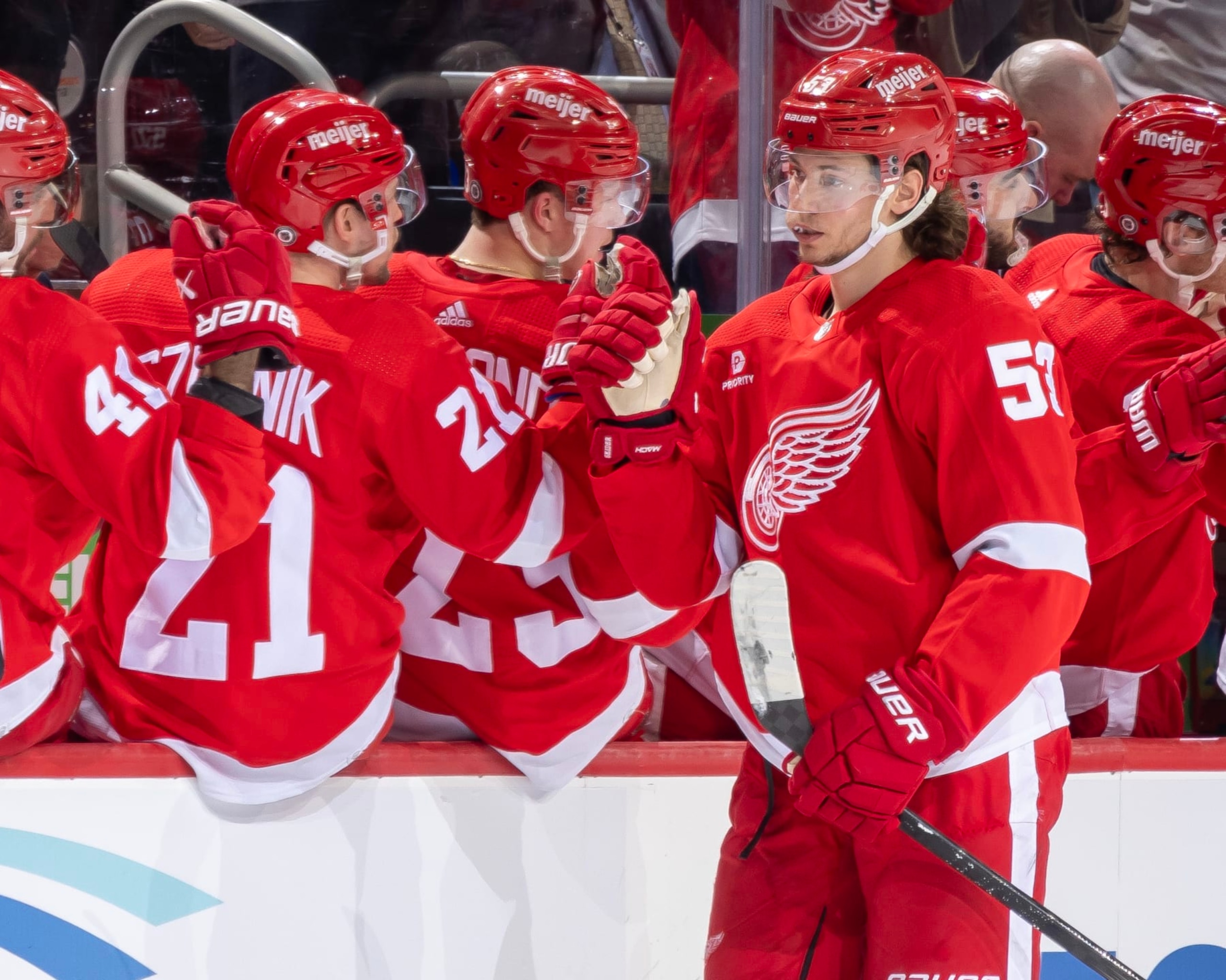 DETROIT, MI - MARCH 19: Moritz Seider (53) of the Detroit Red Wings celebrates his goal against the Columbus Blue Jackets with teammates on the bench during the second period at Little Caesars Arena on March 19, 2024 in Detroit, Michigan. (Photo by Dave Reginek/NHLI via Getty Images)