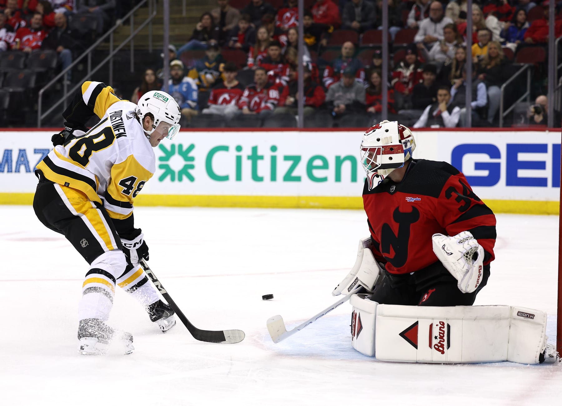 NEWARK, NEW JERSEY - MARCH 19: Valtteri Puustinen #48 of the Pittsburgh Penguins is unable to score as Jake Allen #34 of the New Jersey Devils defends during the first period at Prudential Center on March 19, 2024 in Newark, New Jersey. (Photo by Elsa/Getty Images)
