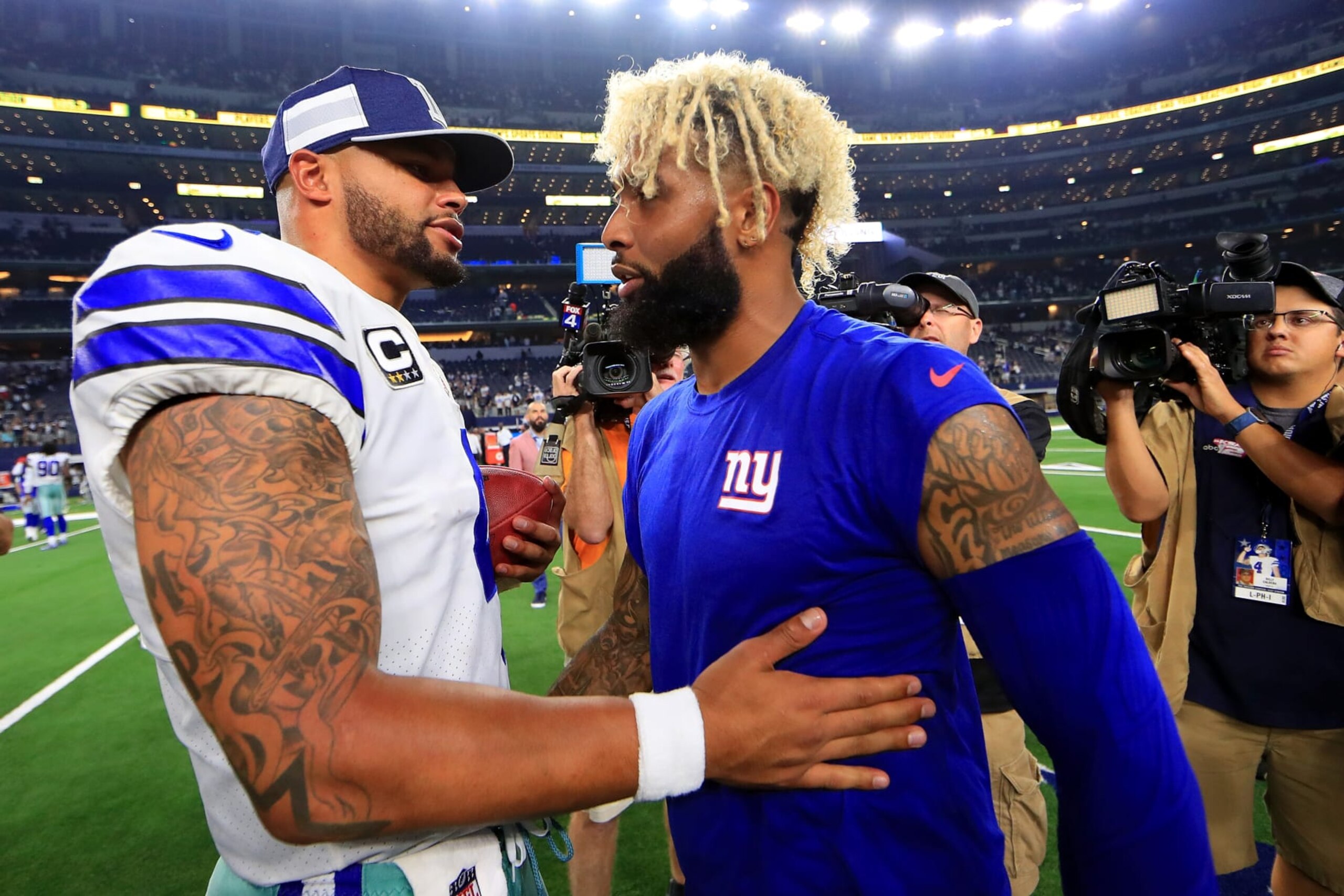 ARLINGTON, TX - SEPTEMBER 16: Dak Prescott #4 of the Dallas Cowboys greets Odell Beckham Jr. #13 of the New York Giants after the Dallas Cowboys beat the New York Giants 20-13 at AT&T Stadium on September 16, 2018 in Arlington, Texas. (Photo by Tom Pennington/Getty Images) ARLINGTON, TX - SEPTEMBER 16: Dak Prescott #4 of the Dallas Cowboys greets Odell Beckham Jr. #13 of the New York Giants after the Dallas Cowboys beat the New York Giants 20-13 at AT&T Stadium on September 16, 2018 in Arlington, Texas. (Photo by Tom Pennington/Getty Images)