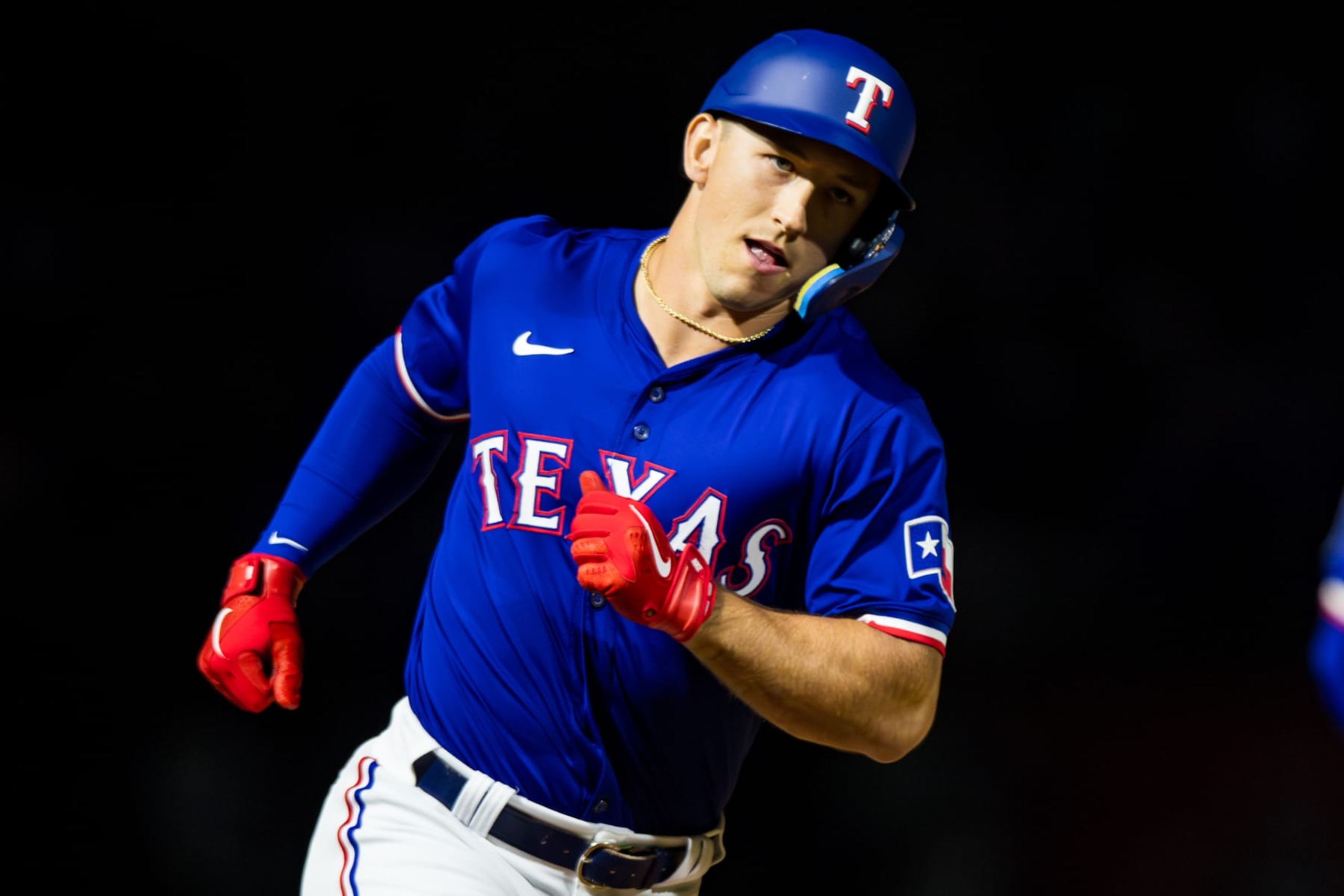 SURPRISE, ARIZONA - MARCH 14: Wyatt Langford #82 of the Texas Rangers rounds the bases after hitting a grand slam during the Spring Training Game against the Cincinnati Reds at Surprise Stadium on March 14, 2024 in Surprise, Arizona. (Photo by John E. Moore III/Getty Images)