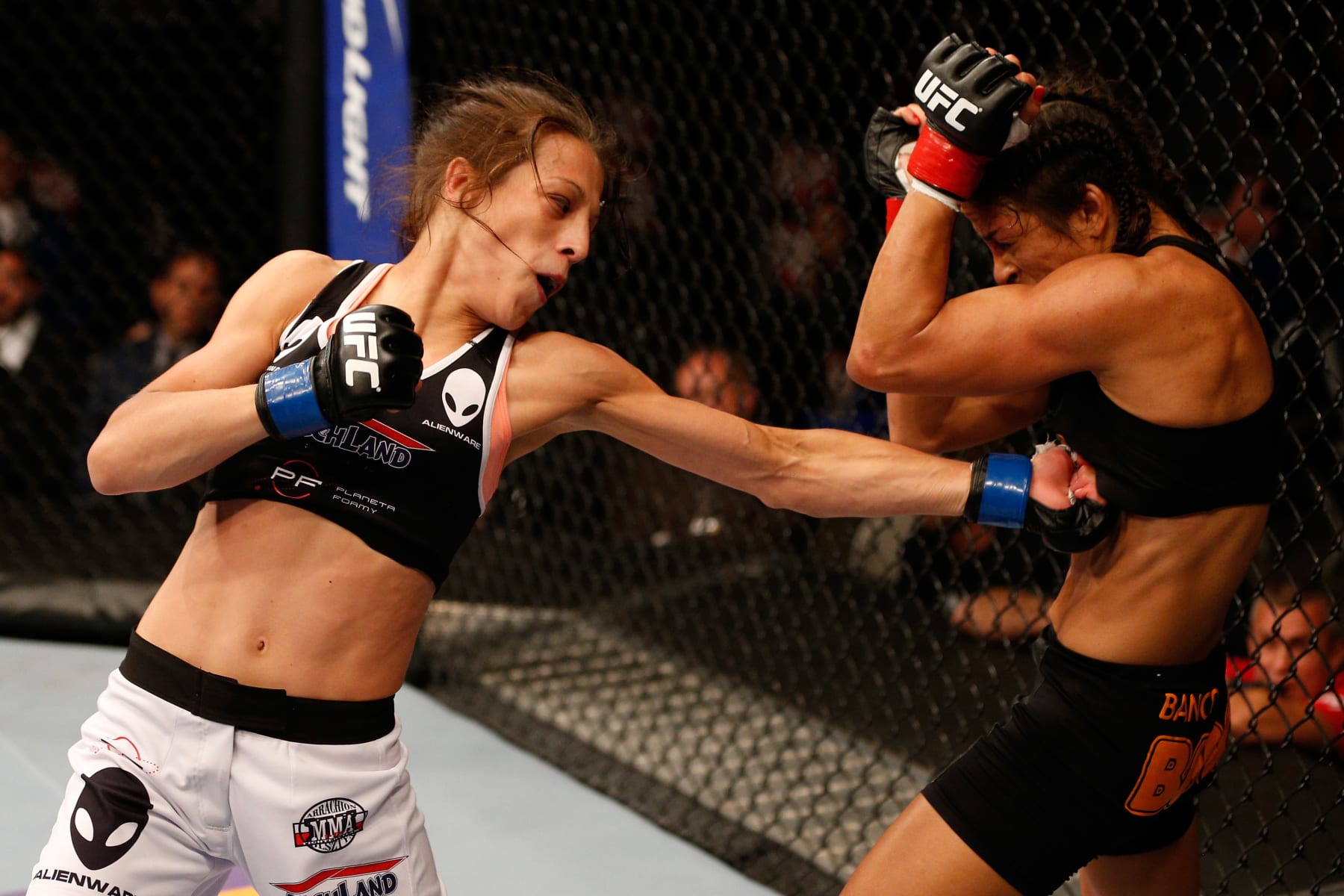 Joanna Jedrzejczyk lands a body punch on Juliana Lima in her UFC debut.