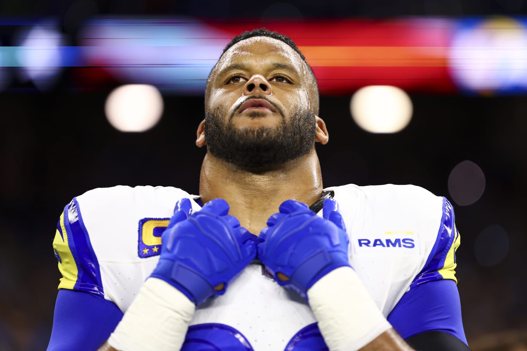 DETROIT, MI - JANUARY 14: Aaron Donald #99 of the Los Angeles Rams stands on the sidelines during the national anthem prior to an NFL wild-card playoff football game against the Detroit Lions at Ford Field on January 14, 2024 in Detroit, Michigan. (Photo by Kevin Sabitus/Getty Images)