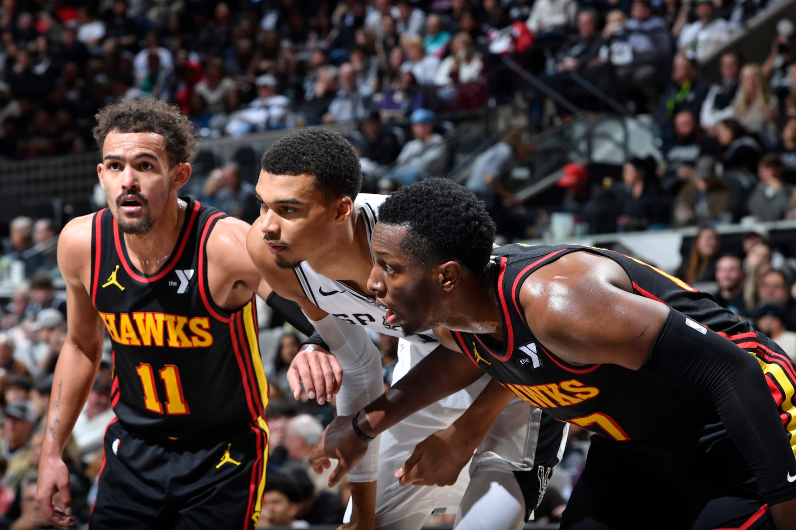 SAN ANTONIO, TX - NOVEMBER 30: Trae Young #11 of the Atlanta Hawks, Victor Wembanyama #1 of the San Antonio Spurs and Onyeka Okongwu #17 of the Atlanta Hawks wait for a rebound during the game on November 30, 2023 at the Frost Bank Center in San Antonio, Texas. NOTE TO USER: User expressly acknowledges and agrees that, by downloading and or using this photograph, user is consenting to the terms and conditions of the Getty Images License Agreement. Mandatory Copyright Notice: Copyright 2023 NBAE (Photos by Logan Riely/NBAE via Getty Images) SAN ANTONIO, TX - NOVEMBER 30: Trae Young #11 of the Atlanta Hawks, Victor Wembanyama #1 of the San Antonio Spurs and Onyeka Okongwu #17 of the Atlanta Hawks wait for a rebound during the game on November 30, 2023 at the Frost Bank Center in San Antonio, Texas. NOTE TO USER: User expressly acknowledges and agrees that, by downloading and or using this photograph, user is consenting to the terms and conditions of the Getty Images License Agreement. Mandatory Copyright Notice: Copyright 2023 NBAE (Photos by Logan Riely/NBAE via Getty Images)