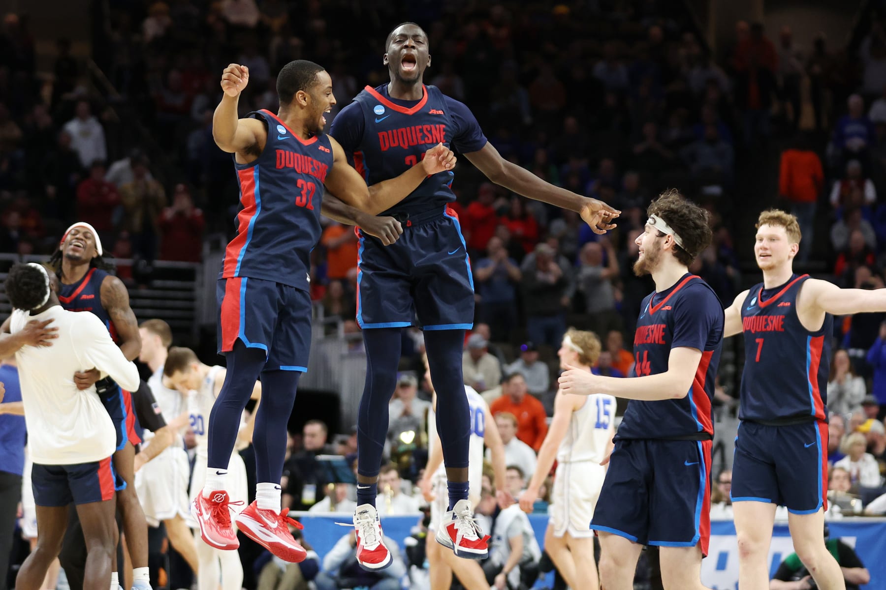 OMAHA, NEBRASKA - MARCH 21:  Kareem Rozier #32 and Fousseyni Drame #34 of the Duquesne Dukes react after defeating the Brigham Young Cougars during the second half in the first round of the NCAA Men's Basketball Tournament at CHI Health Center on March 21, 2024 in Omaha, Nebraska. (Photo by Jamie Squire/Getty Images)