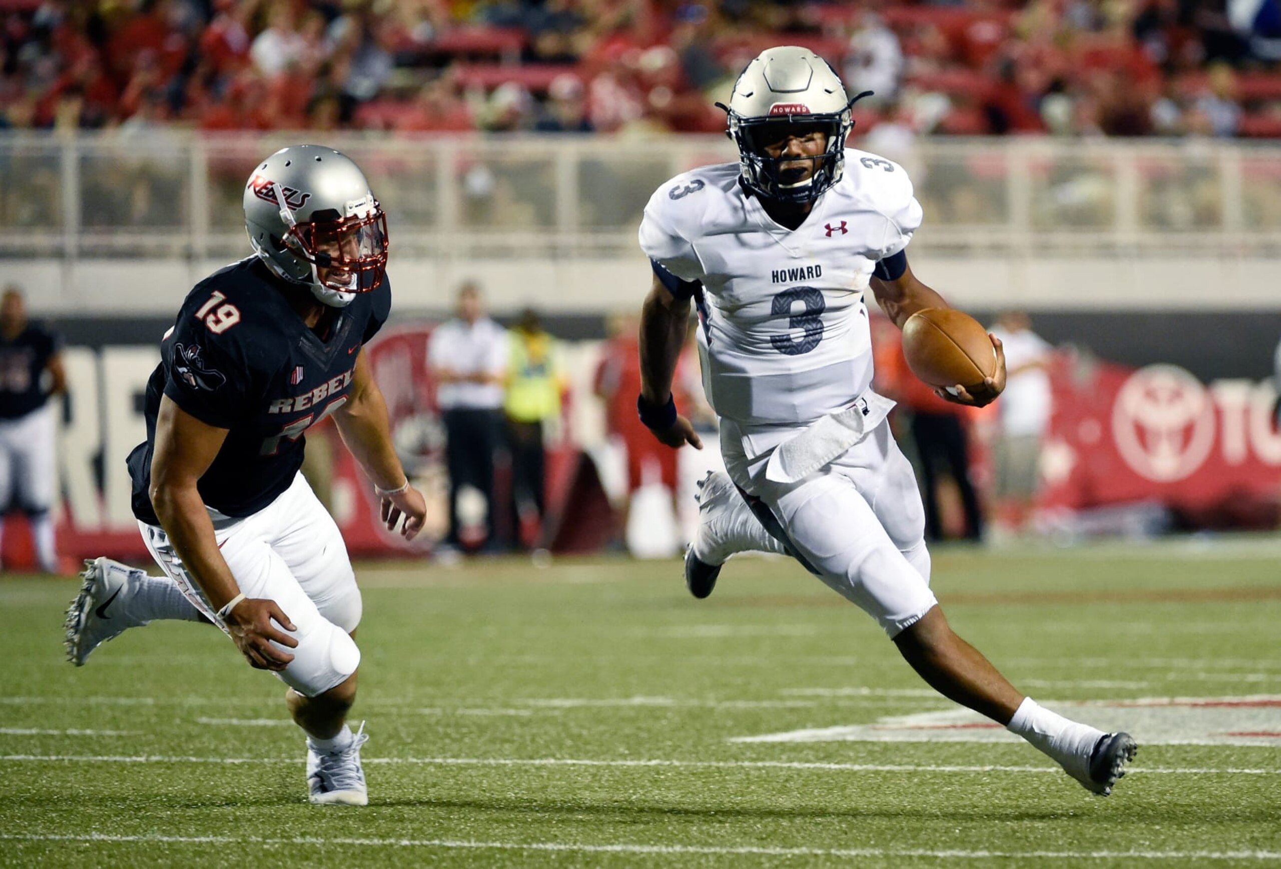 Quarterback Caylin Newton #3 of the Howard Bison runs against defense lineman Mark Finau #19 of the UNLV Rebels 
