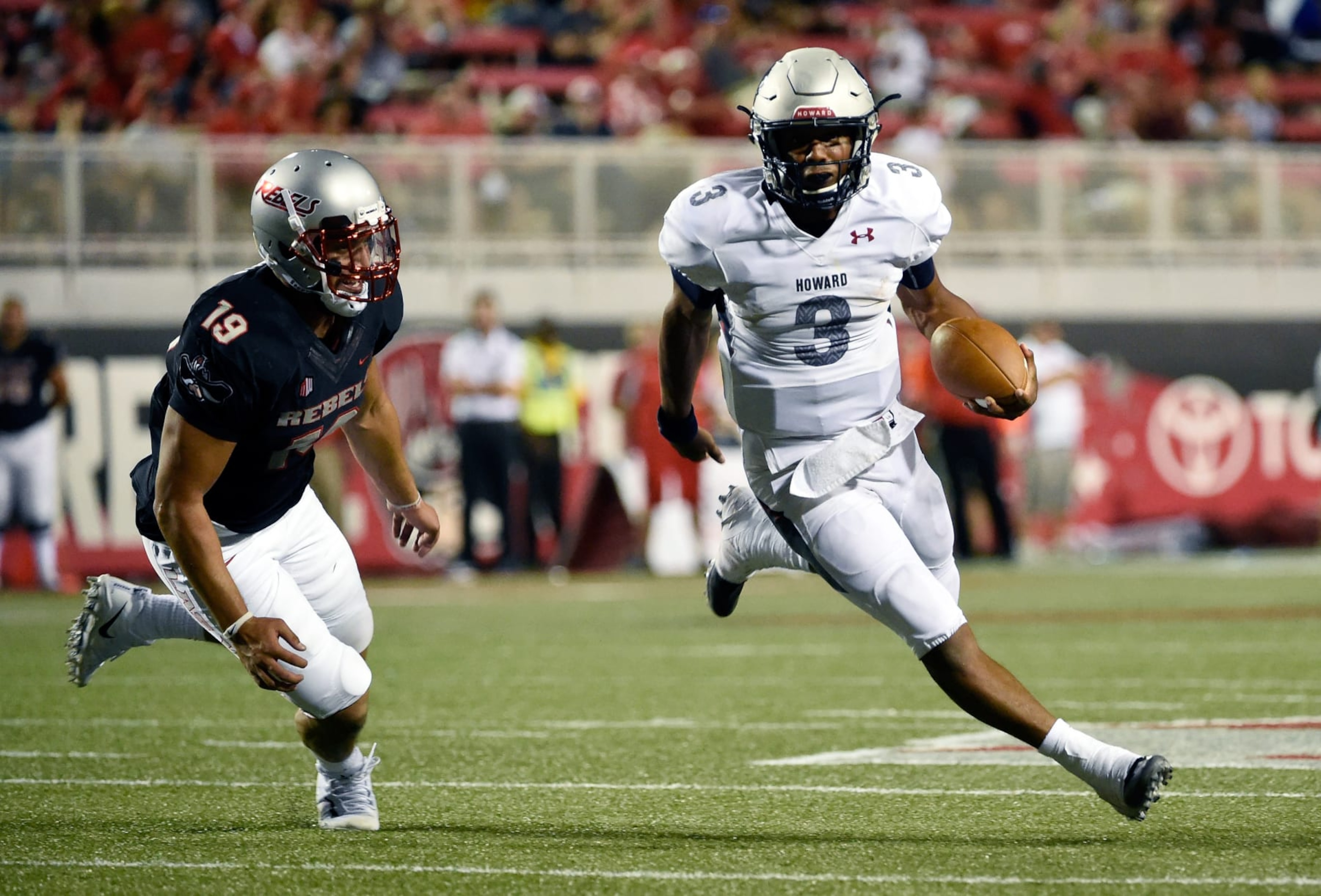 Quarterback Caylin Newton #3 of the Howard Bison runs against defense lineman Mark Finau #19 of the UNLV Rebels Quarterback Caylin Newton #3 of the Howard Bison runs against defense lineman Mark Finau #19 of the UNLV Rebels