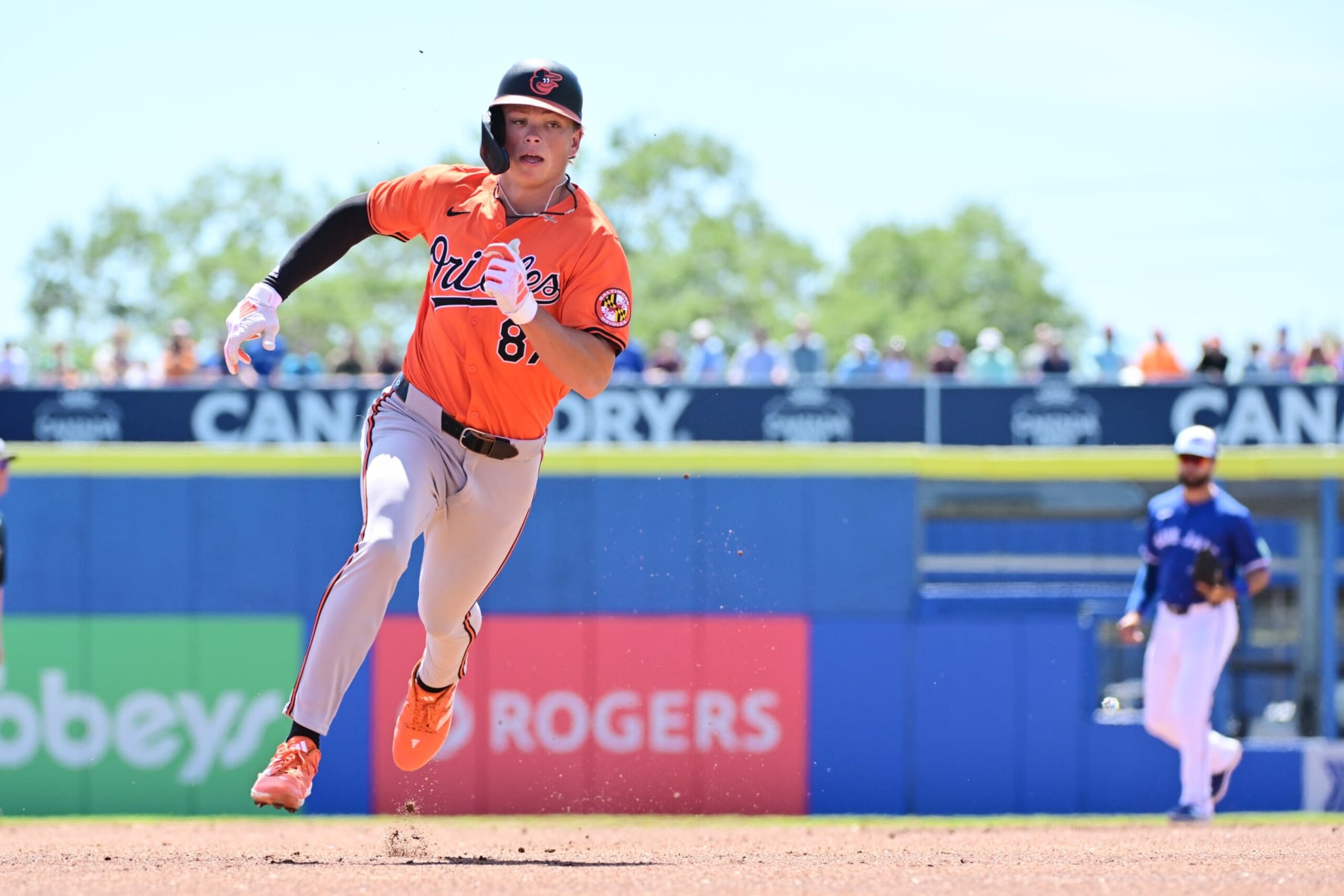DUNEDIN, FLORIDA - MARCH 19: Jackson Holliday #87 of the Baltimore Orioles rounds third base to score in the first inning against the Toronto Blue Jays during a 2024 Grapefruit League Spring Training game at TD Ballpark on March 19, 2024 in Dunedin, Florida. (Photo by Julio Aguilar/Getty Images)