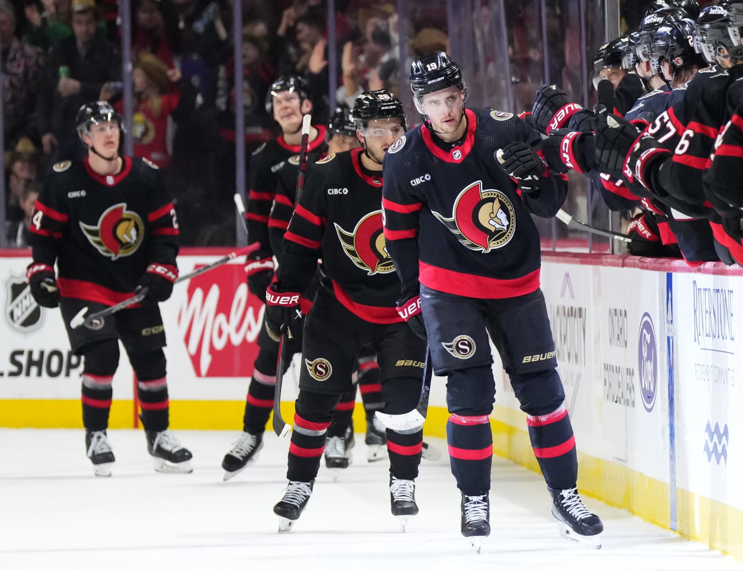 OTTAWA, CANADA - MARCH 1: Drake Batherson #19 of the Ottawa Senators celebrates his second period goal against the Arizona Coyotes with teammates at the players' bench at Canadian Tire Centre on March 1, 2024 in Ottawa, Ontario, Canada. (Photo by Andrea Cardin/NHLI via Getty Images) OTTAWA, CANADA - MARCH 1: Drake Batherson #19 of the Ottawa Senators celebrates his second period goal against the Arizona Coyotes with teammates at the players' bench at Canadian Tire Centre on March 1, 2024 in Ottawa, Ontario, Canada. (Photo by Andrea Cardin/NHLI via Getty Images)