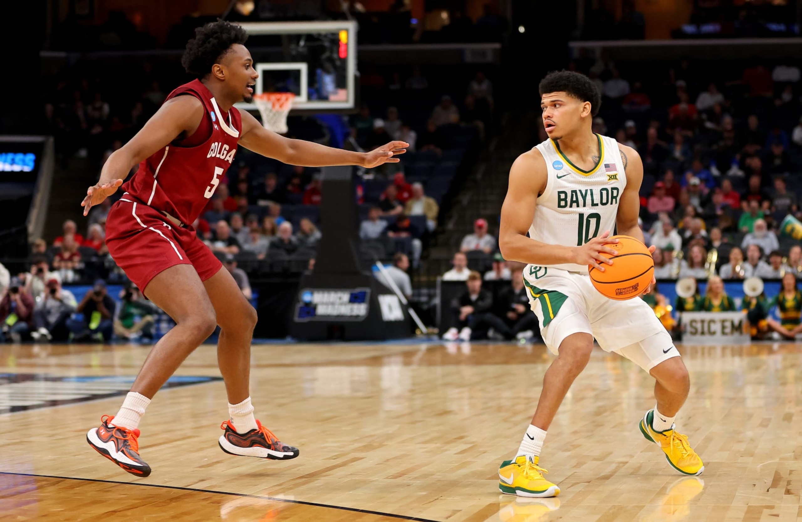 MEMPHIS, TENNESSEE - MARCH 22:  RayJ Dennis #10 of the Baylor Bears is defended by Nicolas Louis-Jacques #5 of the Colgate Raiders in the first round of the NCAA Men's Basketball Tournament  at FedExForum on March 22, 2024 in Memphis, Tennessee. (Photo by Stacy Revere/Getty Images)