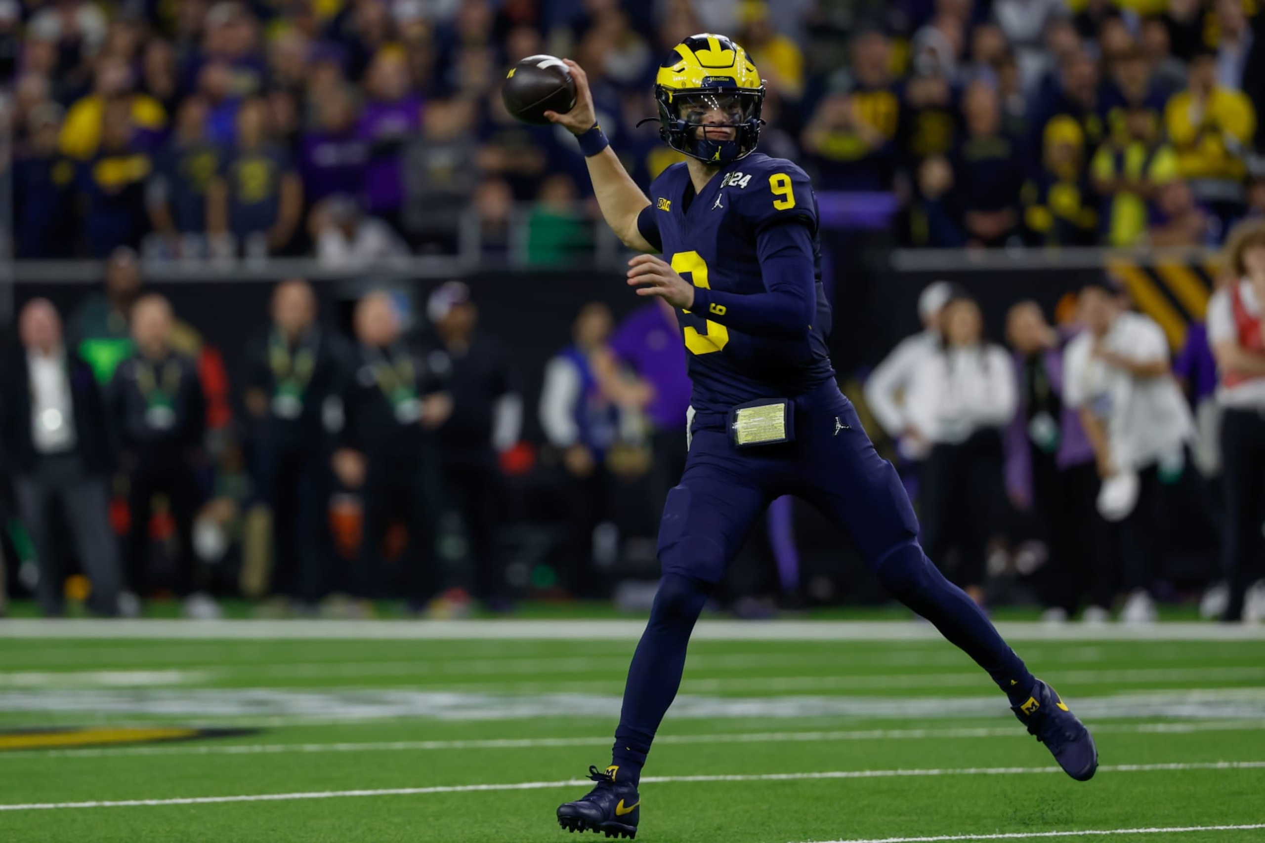 HOUSTON, TX - JANUARY 08: Michigan Wolverines quarterback J.J. McCarthy (9) rolls out for a pass during the CFP National Championship game Michigan Wolverines and Washington Huskies on January 8, 2024, at NRG Stadium in Houston, Texas. (Photo by David Buono/Icon Sportswire via Getty Images) HOUSTON, TX - JANUARY 08: Michigan Wolverines quarterback J.J. McCarthy (9) rolls out for a pass during the CFP National Championship game Michigan Wolverines and Washington Huskies on January 8, 2024, at NRG Stadium in Houston, Texas. (Photo by David Buono/Icon Sportswire via Getty Images)