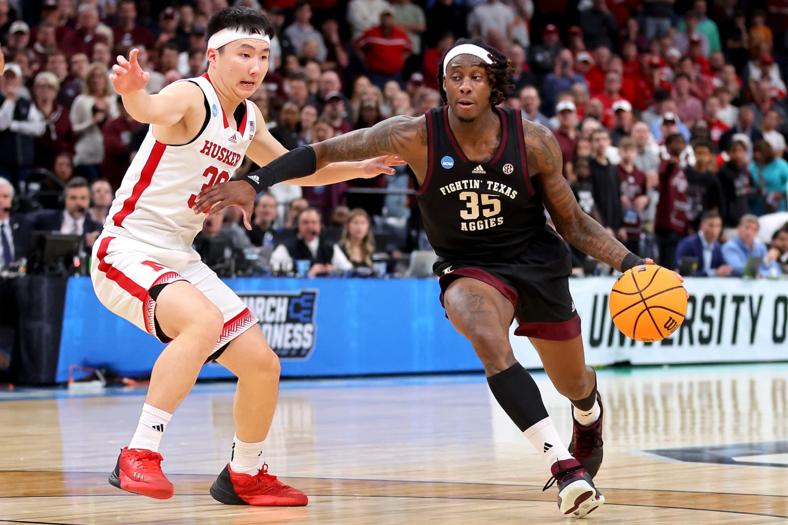 MEMPHIS, TENNESSEE - MARCH 22:  Manny Obaseki #35 of the Texas A&M Aggies is defended by Keisei Tominaga #30 of the Nebraska Cornhuskers during the first half in the first round of the NCAA Men's Basketball Tournament at FedExForum on March 22, 2024 in Memphis, Tennessee. (Photo by Stacy Revere/Getty Images)