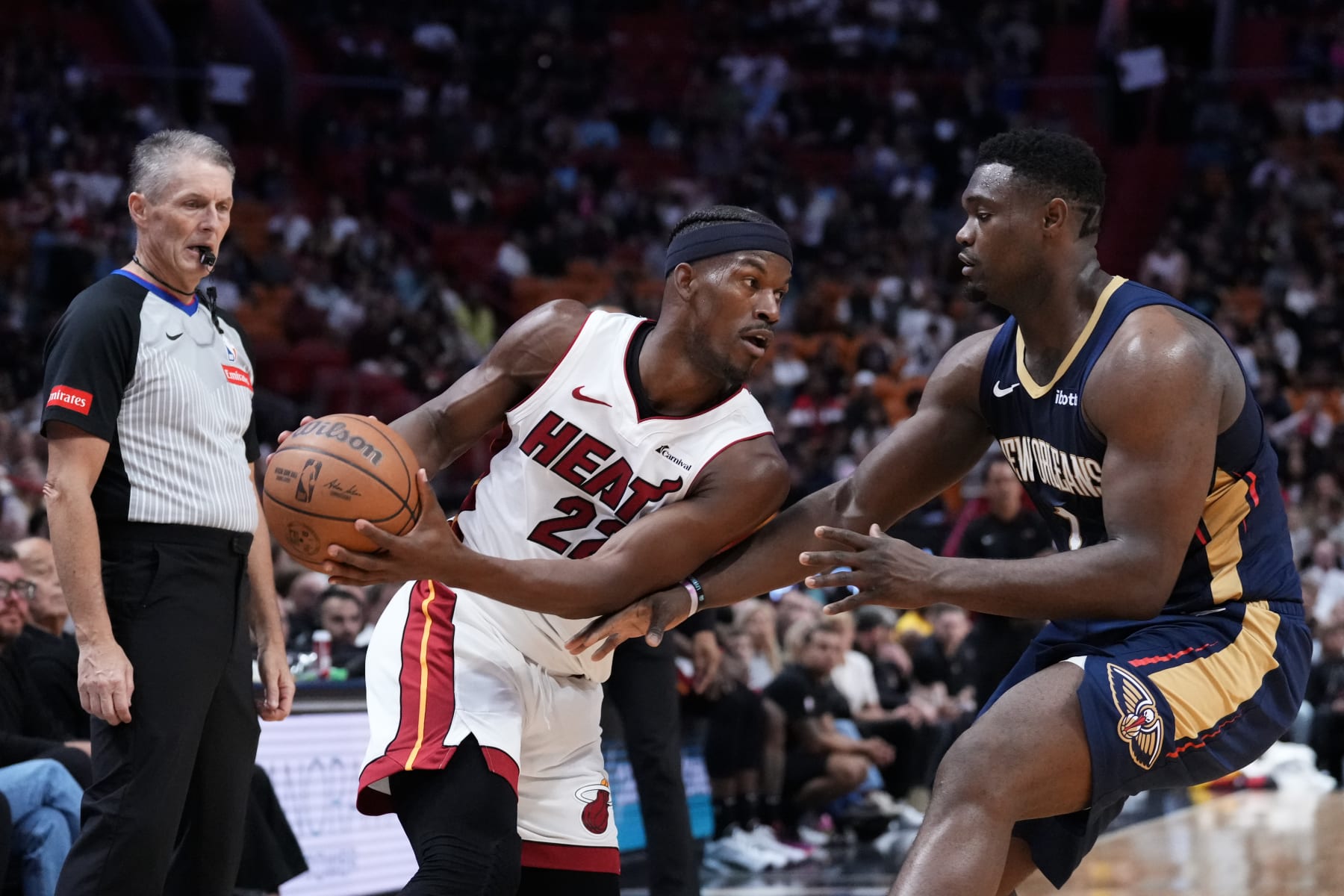 MIAMI, FLORIDA - MARCH 22: Jimmy Butler #22 of the Miami Heat dribbles the ball against Zion Williamson #1 of the New Orleans Pelicans during the second quarter at Kaseya Center on March 22, 2024 in Miami, Florida. NOTE TO USER: User expressly acknowledges and agrees that, by downloading and or using this photograph, User is consenting to the terms and conditions of the Getty Images License Agreement. (Photo by Rich Storry/Getty Images)