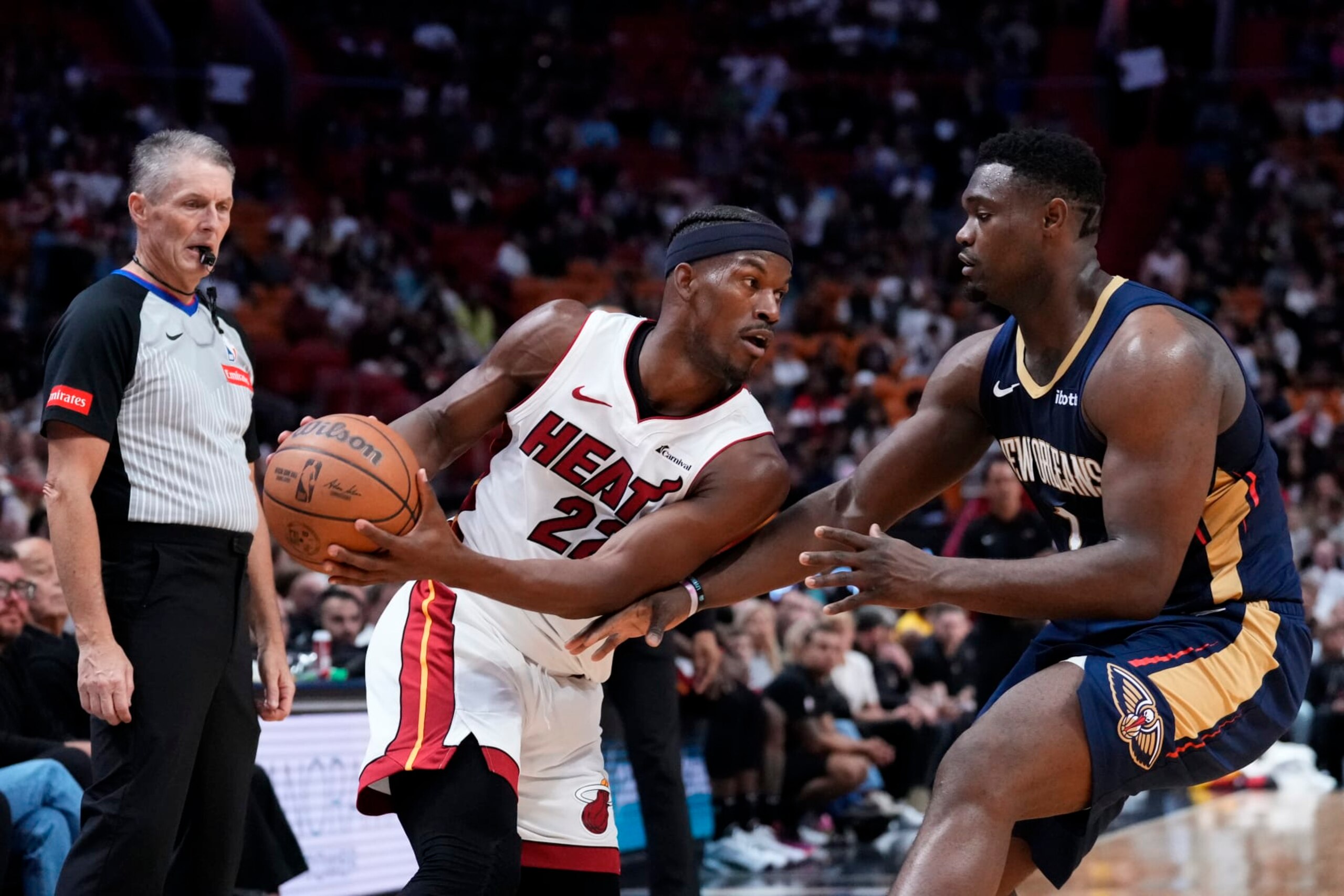 MIAMI, FLORIDA - MARCH 22: Jimmy Butler #22 of the Miami Heat dribbles the ball against Zion Williamson #1 of the New Orleans Pelicans during the second quarter at Kaseya Center on March 22, 2024 in Miami, Florida. NOTE TO USER: User expressly acknowledges and agrees that, by downloading and or using this photograph, User is consenting to the terms and conditions of the Getty Images License Agreement. (Photo by Rich Storry/Getty Images) MIAMI, FLORIDA - MARCH 22: Jimmy Butler #22 of the Miami Heat dribbles the ball against Zion Williamson #1 of the New Orleans Pelicans during the second quarter at Kaseya Center on March 22, 2024 in Miami, Florida. NOTE TO USER: User expressly acknowledges and agrees that, by downloading and or using this photograph, User is consenting to the terms and conditions of the Getty Images License Agreement. (Photo by Rich Storry/Getty Images)