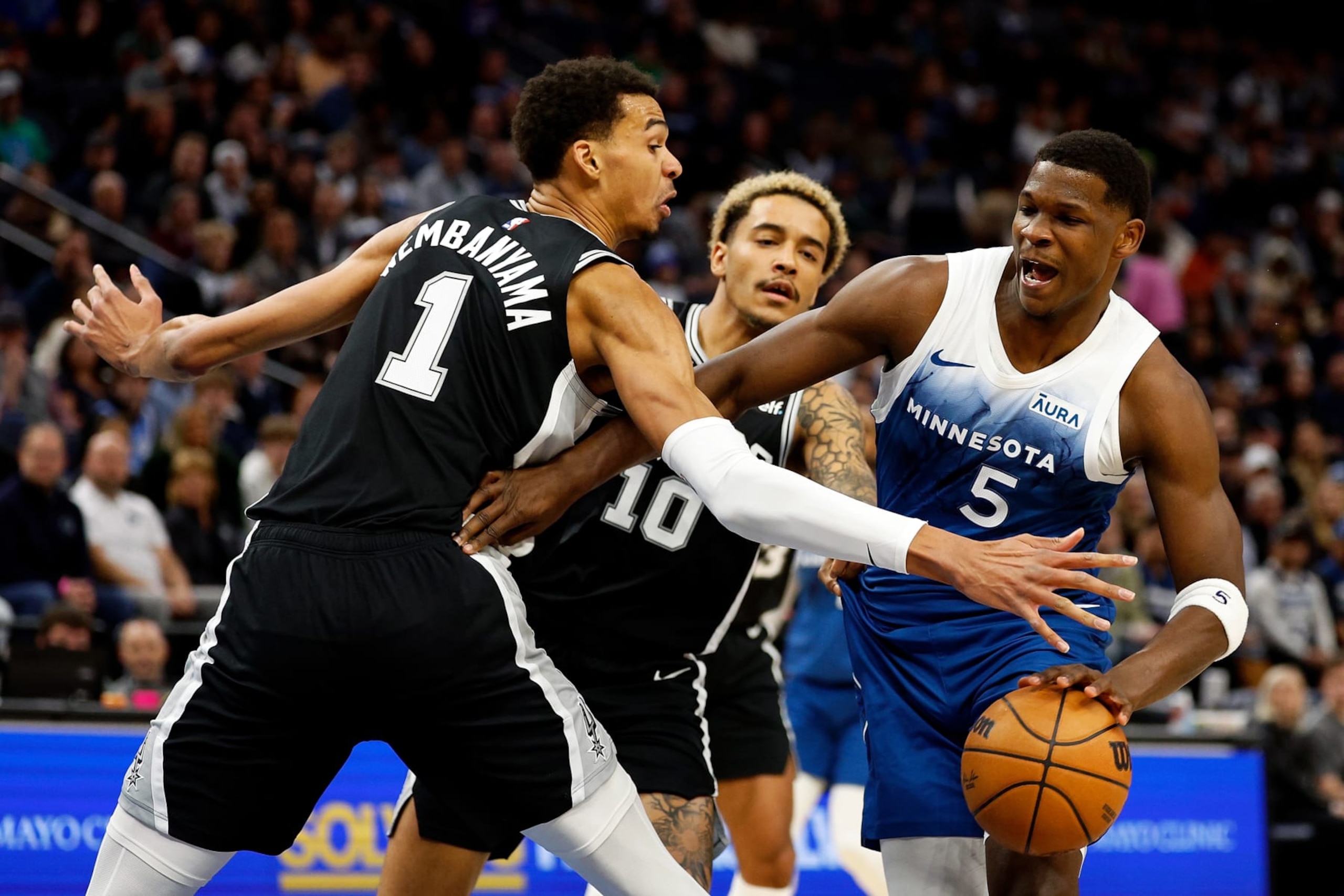 MINNEAPOLIS, MINNESOTA - FEBRUARY 27: Anthony Edwards #5 of the Minnesota Timberwolves drives to the basket against Victor Wembanyama #1 of the San Antonio Spurs in the first quarter at Target Center on February 27, 2024 in Minneapolis, Minnesota. NOTE TO USER: User expressly acknowledges and agrees that, by downloading and or using this photograph, User is consenting to the terms and conditions of the Getty Images License Agreement. (Photo by David Berding/Getty Images)