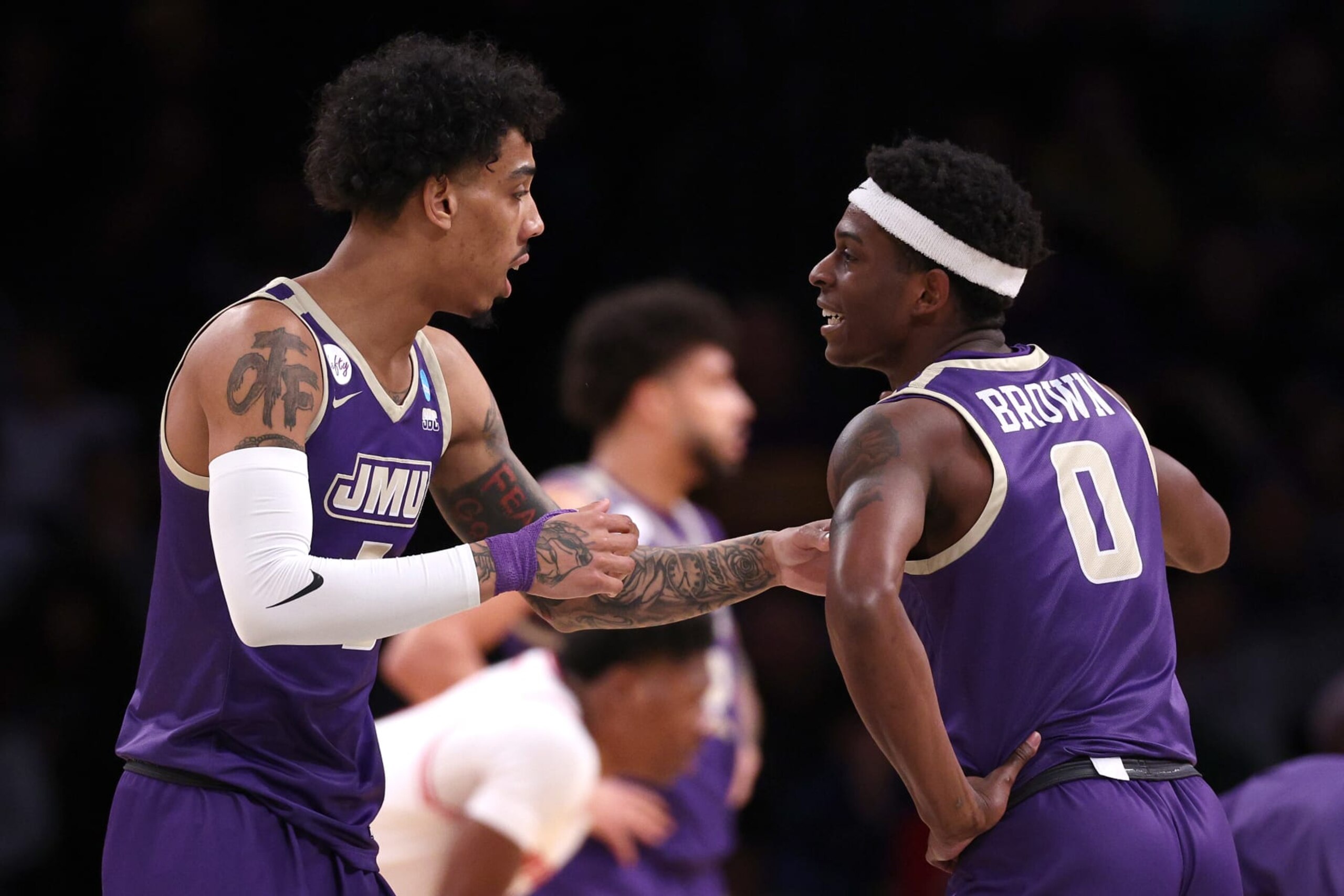 NEW YORK, NEW YORK - MARCH 22: Terrence Edwards Jr. #5 of the James Madison Dukes talks with Xavier Brown #0 during the first half against the Wisconsin Badgers in the first round of the NCAA Men's Basketball Tournament at Barclays Center on March 22, 2024 in New York City. (Photo by Elsa/Getty Images)