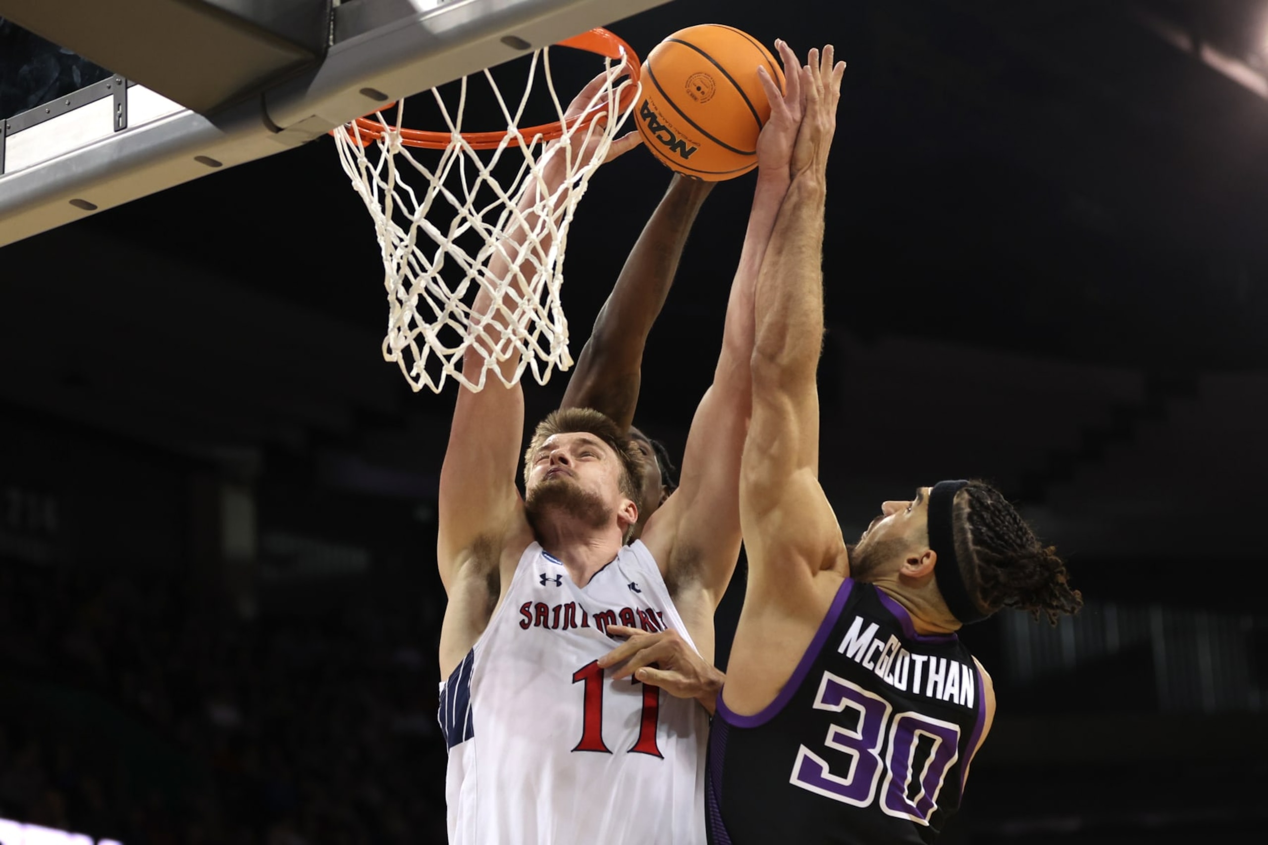 SPOKANE, WASHINGTON - MARCH 22: Tyon Grant-Foster #7 and Gabe McGlothan #30 of the Grand Canyon Antelopes block the dunk attempt by Mitchell Saxen #11 of the St. Mary's Gaels during the first half in the first round of the NCAA Men's Basketball Tournament at Spokane Veterans Memorial Arena on March 22, 2024 in Spokane, Washington. (Photo by Steph Chambers/Getty Images)