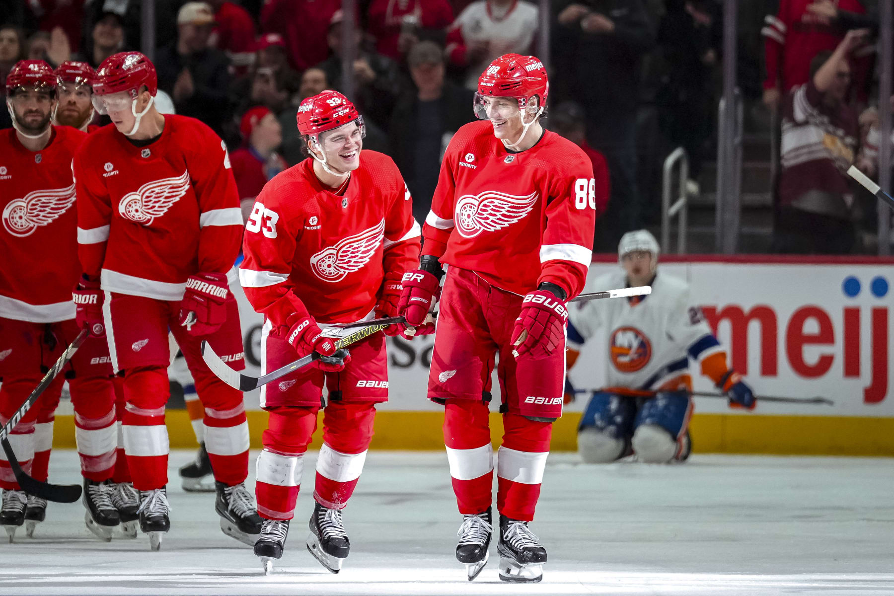 DETROIT, MICHIGAN - MARCH 21: Alex DeBrincat #93 and Patrick Kane #88 of the Detroit Red Wings celebrate Kane's goal against the New York Islanders during the third period at Little Caesars Arena on March 21, 2024 in Detroit, Michigan. (Photo by Nic Antaya/Getty Images)