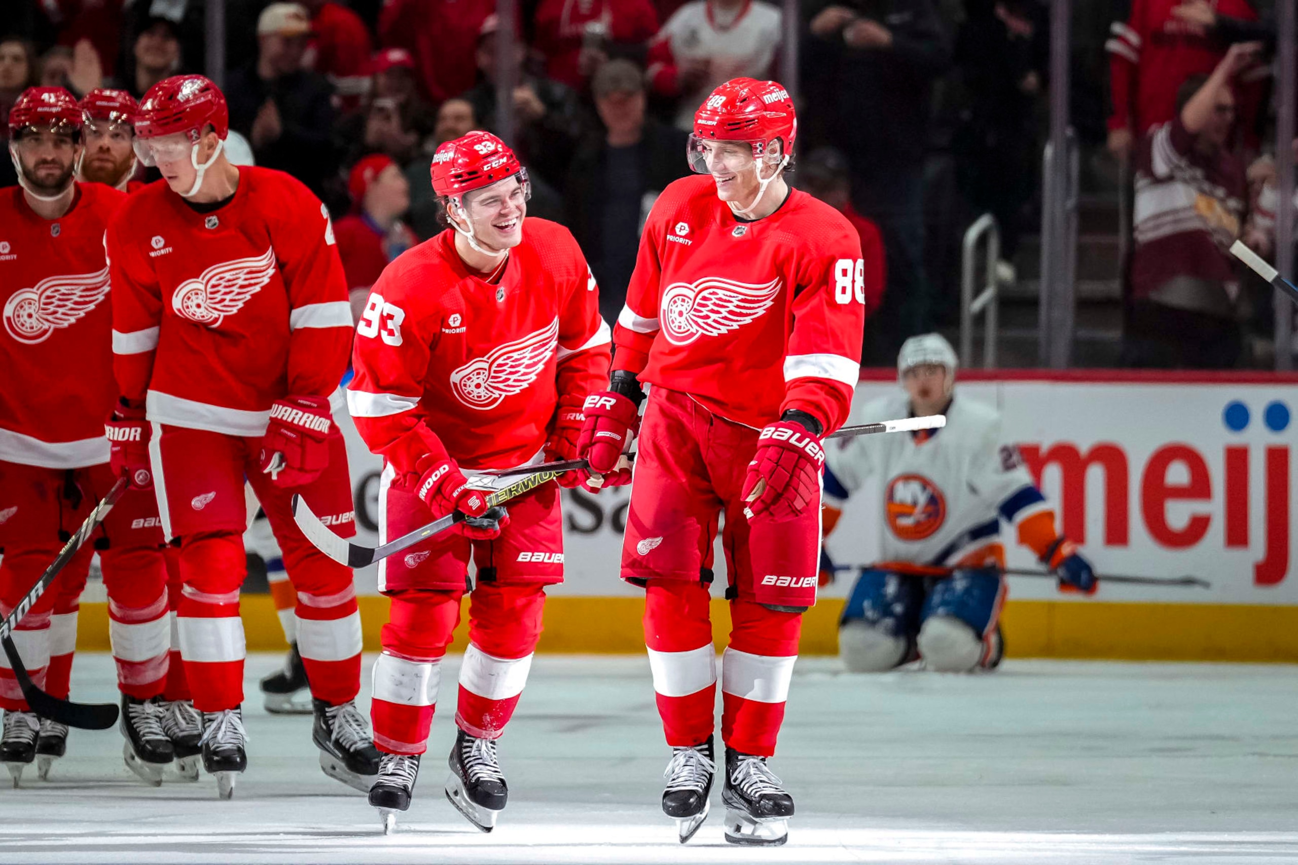 DETROIT, MICHIGAN - MARCH 21: Alex DeBrincat #93 and Patrick Kane #88 of the Detroit Red Wings celebrate Kane's goal against the New York Islanders during the third period at Little Caesars Arena on March 21, 2024 in Detroit, Michigan. (Photo by Nic Antaya/Getty Images)