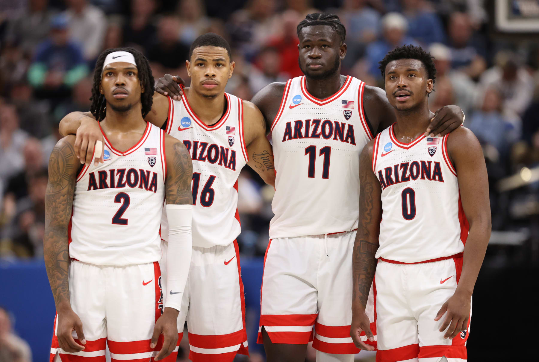 SALT LAKE CITY, UTAH - MARCH 23: (L-R) Caleb Love #2, Keshad Johnson #16, Oumar Ballo #11, and Jaden Bradley #0 of the Arizona Wildcats look on as Pelle Larsson #3 (not pictured) shoots free throws against the Dayton Flyers during the second half in the second round of the NCAA Men's Basketball Tournament at Delta Center on March 23, 2024 in Salt Lake City, Utah. (Photo by Christian Petersen/Getty Images)