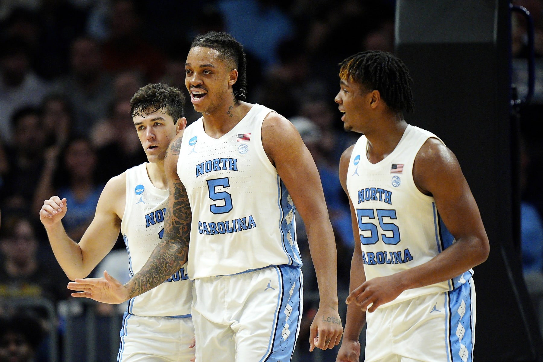 CHARLOTTE, NORTH CAROLINA - MARCH 23: Cormac Ryan #3, Armando Bacot #5 and Harrison Ingram #55 of the North Carolina Tar Heels react to a play during the first half against the Michigan State Spartans in the second round of the NCAA Men's Basketball Tournament at Spectrum Center on March 23, 2024 in Charlotte, North Carolina. (Photo by Jacob Kupferman/Getty Images)