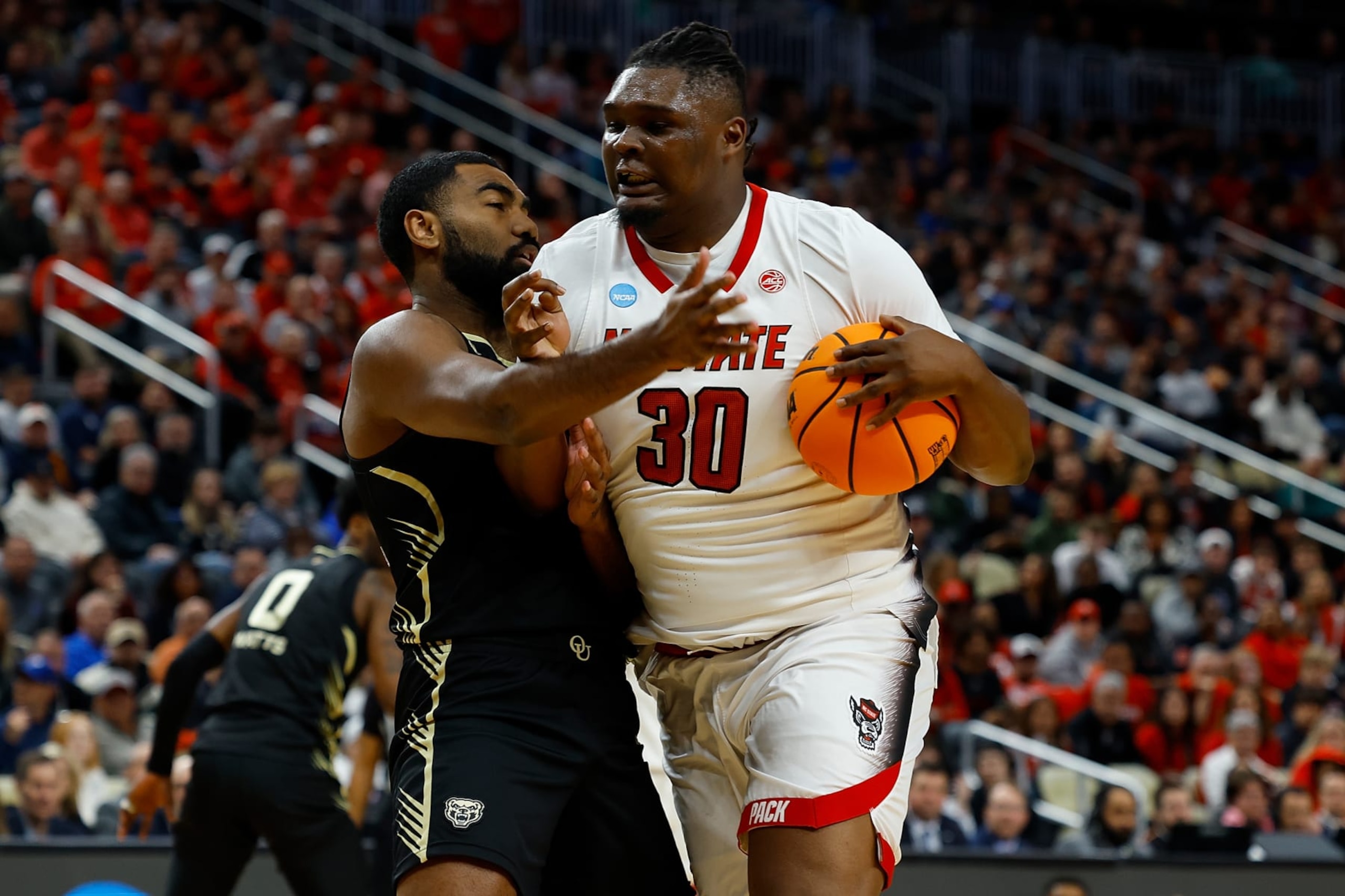 PITTSBURGH, PENNSYLVANIA - MARCH 23: DJ Burns Jr. #30 of the North Carolina State Wolfpack goes to the basket against Tuburu Naivalurua #12 of the Oakland Golden Grizzlies in the first half during the second round of the 2024 NCAA Men's Basketball Tournament held at PPG PAINTS Arena on March 23, 2024 in Pittsburgh, Pennsylvania. (Photo by Justin K. Aller/NCAA Photos via Getty Images) PITTSBURGH, PENNSYLVANIA - MARCH 23: DJ Burns Jr. #30 of the North Carolina State Wolfpack goes to the basket against Tuburu Naivalurua #12 of the Oakland Golden Grizzlies in the first half during the second round of the 2024 NCAA Men's Basketball Tournament held at PPG PAINTS Arena on March 23, 2024 in Pittsburgh, Pennsylvania. (Photo by Justin K. Aller/NCAA Photos via Getty Images)