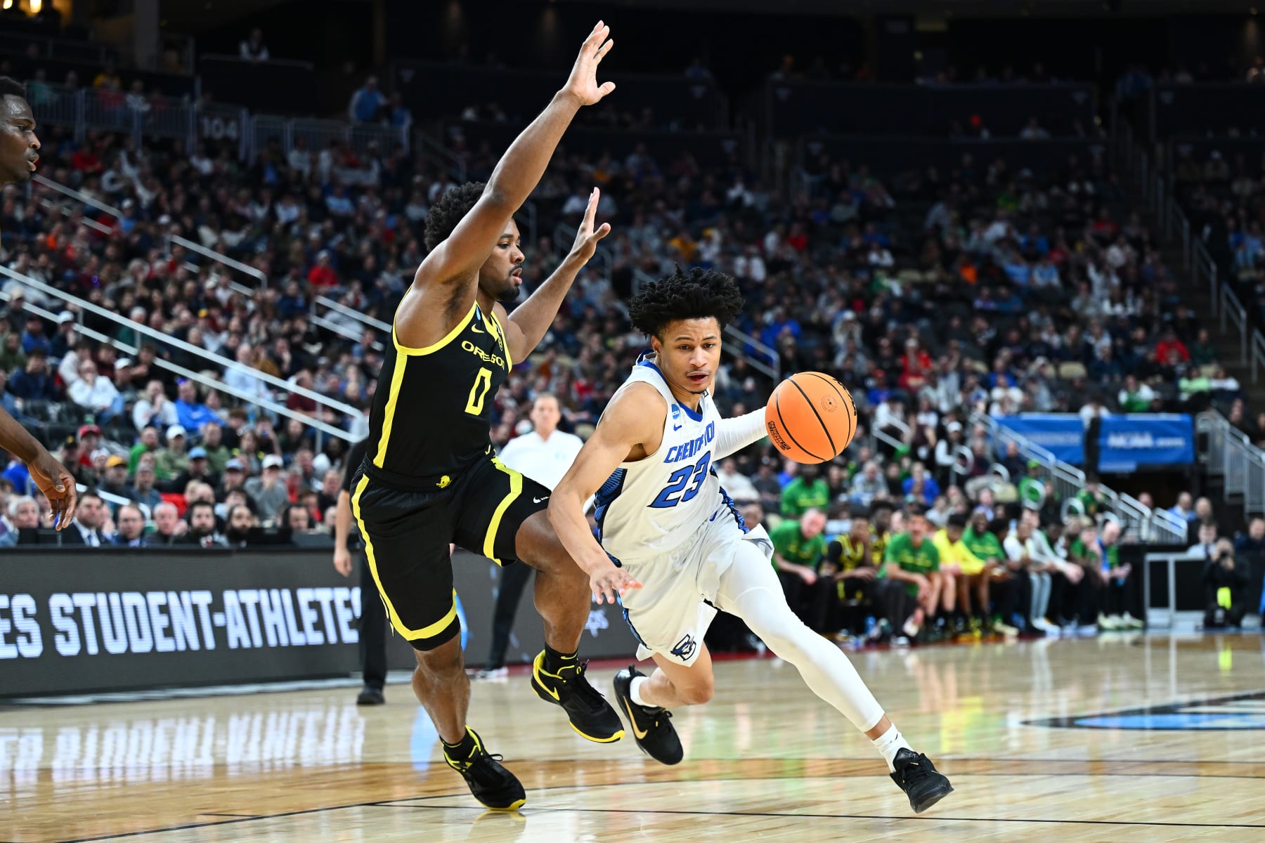 PITTSBURGH, PENNSYLVANIA - MARCH 23: Trey Alexander #23 of the Creighton Bluejays dribbles past Kario Oquendo #0 of the Oregon Ducks during the second half of a game in the second round of the NCAA Men's Basketball Tournament at PPG PAINTS Arena on March 23, 2024 in Pittsburgh, Pennsylvania. (Photo by Joe Sargent/Getty Images)