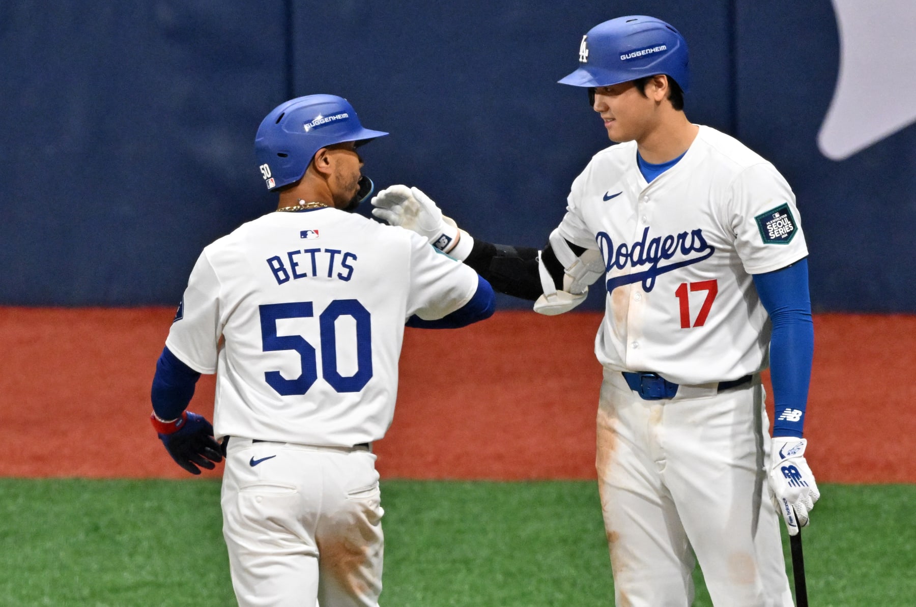 Los Angeles Dodgers' Mookie Betts (L) celebrates with teammate Shohei Ohtani (R) after hitting a two run home run in the 5th inning of the 2024 MLB Seoul Series baseball game 2 between Los Angeles Dodgers and San Diego Padres at the Gocheok Sky Dome in Seoul on March 21, 2024. (Photo by Jung Yeon-je / AFP) (Photo by JUNG YEON-JE/AFP via Getty Images)