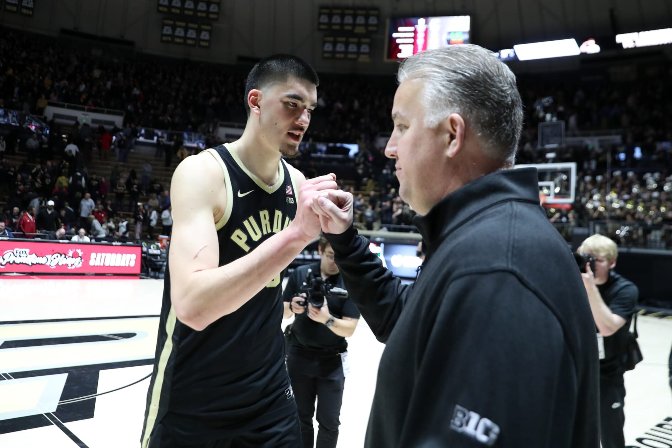 WEST LAFAYETTE, IN - FEBRUARY 10:  Purdue Boilermakers center Zach Edey (15) fist bumps coach Matt Painter after the game against the Indiana Hoosiers on February 10, 2024, at Mackey Arena in West Lafayette, Indiana. (Photo by Brian Spurlock/Icon Sportswire via Getty Images)