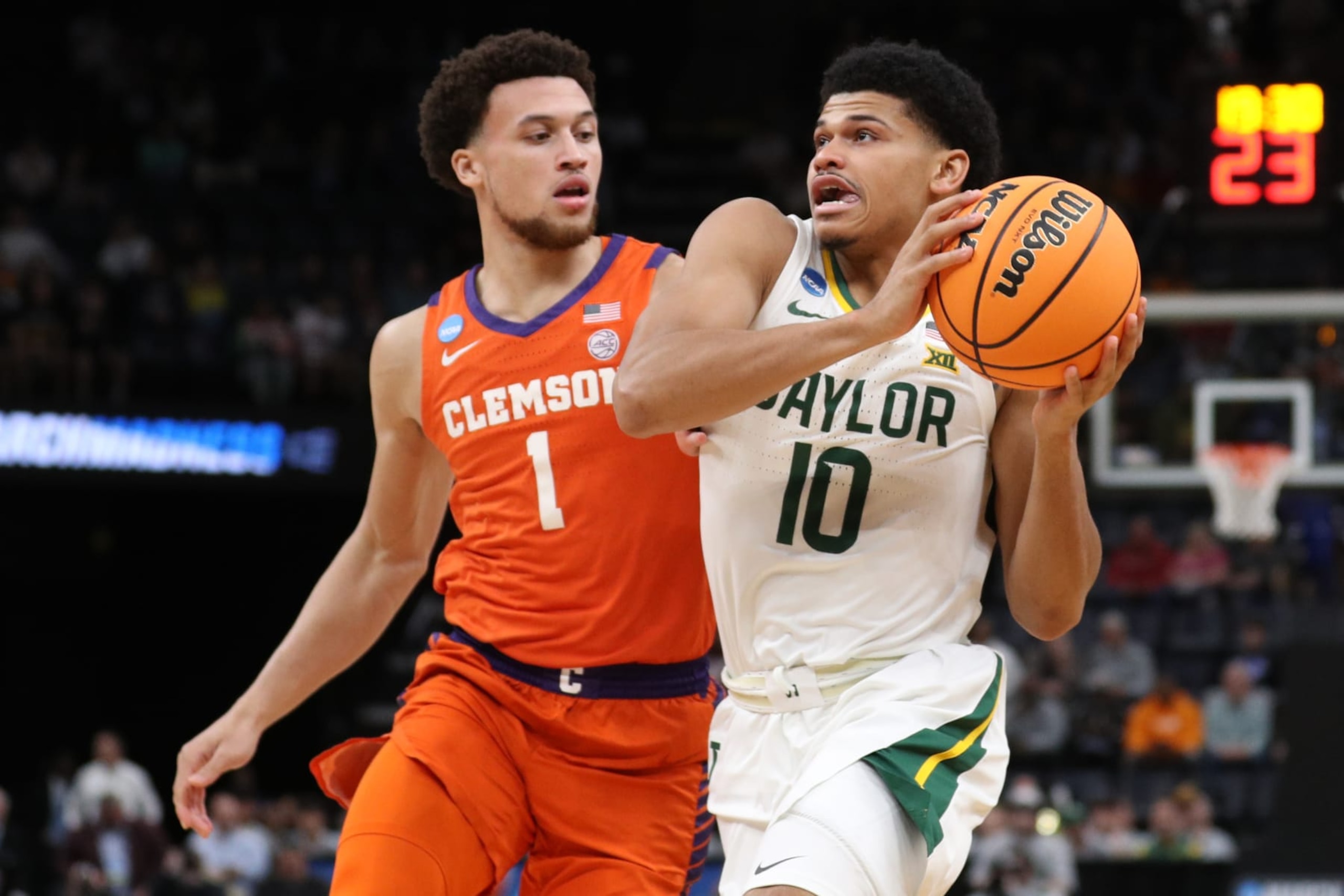 MEMPHIS, TENNESSEE - MARCH 24: RayJ Dennis #10 of the Baylor Bears drives to the basket against Chase Hunter #1 of the Clemson Tigers during the first half in the second round of the NCAA Men's Basketball Tournament at FedExForum on March 24, 2024 in Memphis, Tennessee. (Photo by Justin Ford/Getty Images) MEMPHIS, TENNESSEE - MARCH 24: RayJ Dennis #10 of the Baylor Bears drives to the basket against Chase Hunter #1 of the Clemson Tigers during the first half in the second round of the NCAA Men's Basketball Tournament at FedExForum on March 24, 2024 in Memphis, Tennessee. (Photo by Justin Ford/Getty Images)