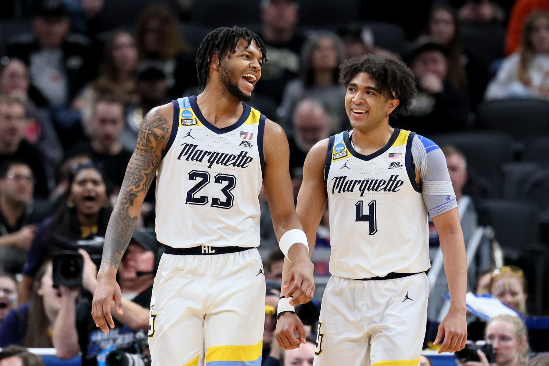 INDIANAPOLIS, INDIANA - MARCH 24: David Joplin #23 and Stevie Mitchell #4 of the Marquette Golden Eagles talk against the Colorado Buffaloes during the first half in the second round of the NCAA Men's Basketball Tournament at Gainbridge Fieldhouse on March 24, 2024 in Indianapolis, Indiana. (Photo by Andy Lyons/Getty Images)