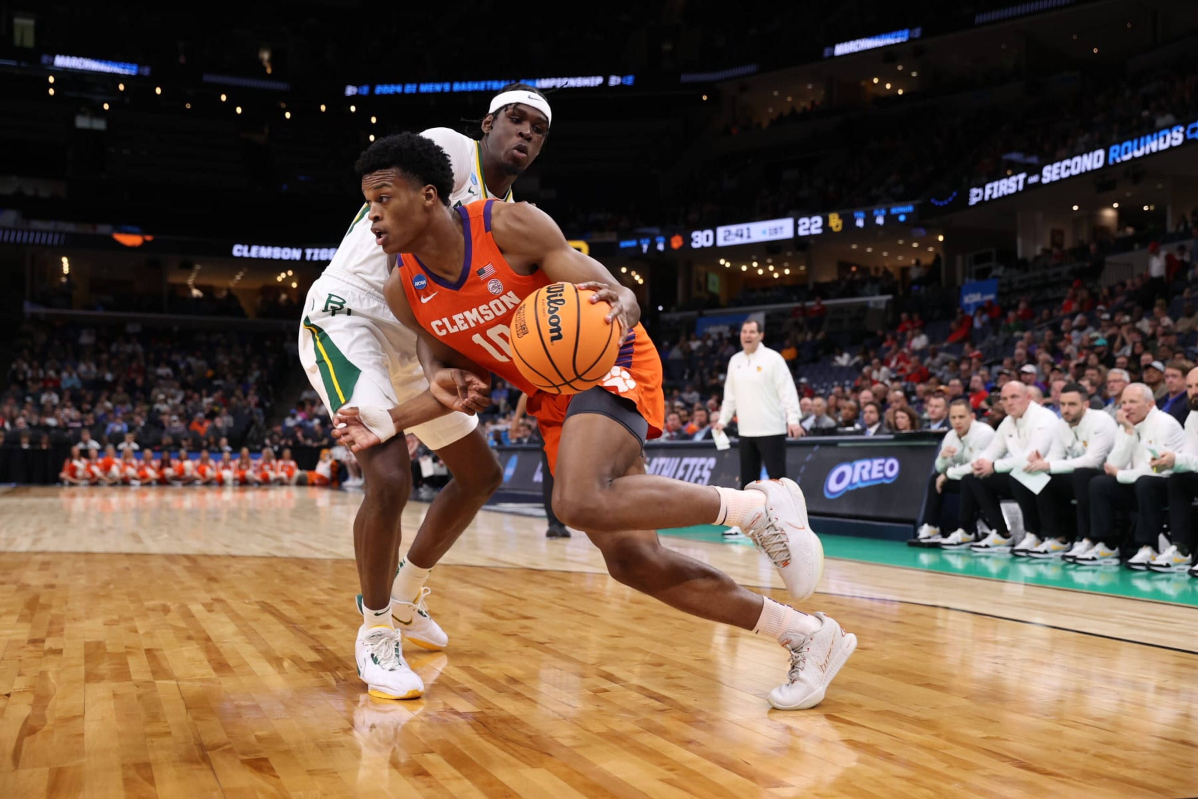 MEMPHIS, TENNESSEE - MARCH 24: RJ Godfrey #10 of the Clemson Tigers drives the ball around Josh Ojianwuna #15 of the Baylor Bears during the second round of the 2024 NCAA Men's Basketball Tournament held at FedExForum on March 24, 2024 in Memphis, Tennessee. (Photo by Joe Murphy/NCAA Photos via Getty Images) MEMPHIS, TENNESSEE - MARCH 24: RJ Godfrey #10 of the Clemson Tigers drives the ball around Josh Ojianwuna #15 of the Baylor Bears during the second round of the 2024 NCAA Men's Basketball Tournament held at FedExForum on March 24, 2024 in Memphis, Tennessee. (Photo by Joe Murphy/NCAA Photos via Getty Images)
