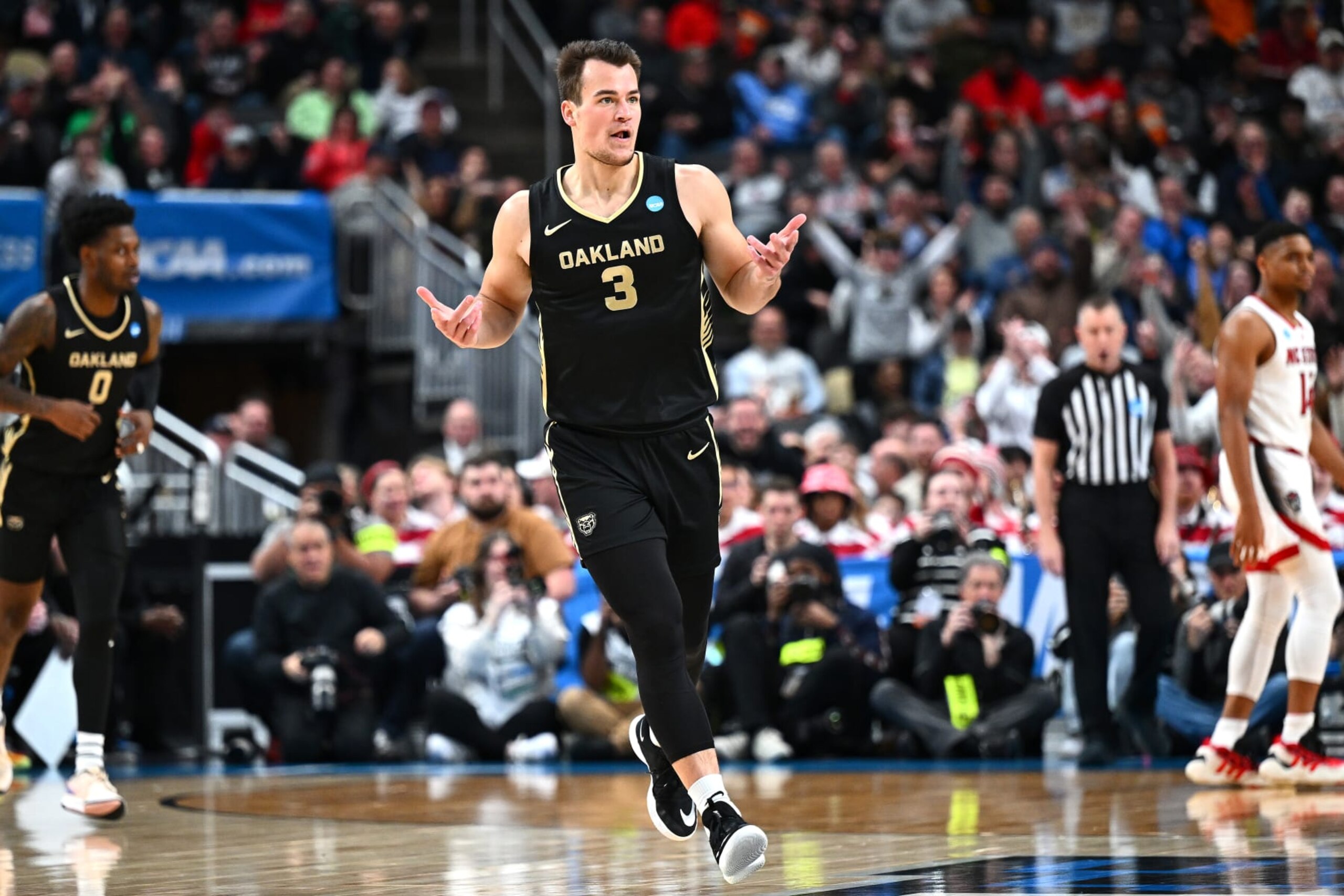 PITTSBURGH, PENNSYLVANIA - MARCH 23: Jack Gohlke #3 of the Oakland Golden Grizzlies reacts during the first half of a game against the North Carolina State Wolfpack in the second round of the NCAA Men's Basketball Tournament at PPG PAINTS Arena on March 23, 2024 in Pittsburgh, Pennsylvania. (Photo by Joe Sargent/Getty Images)