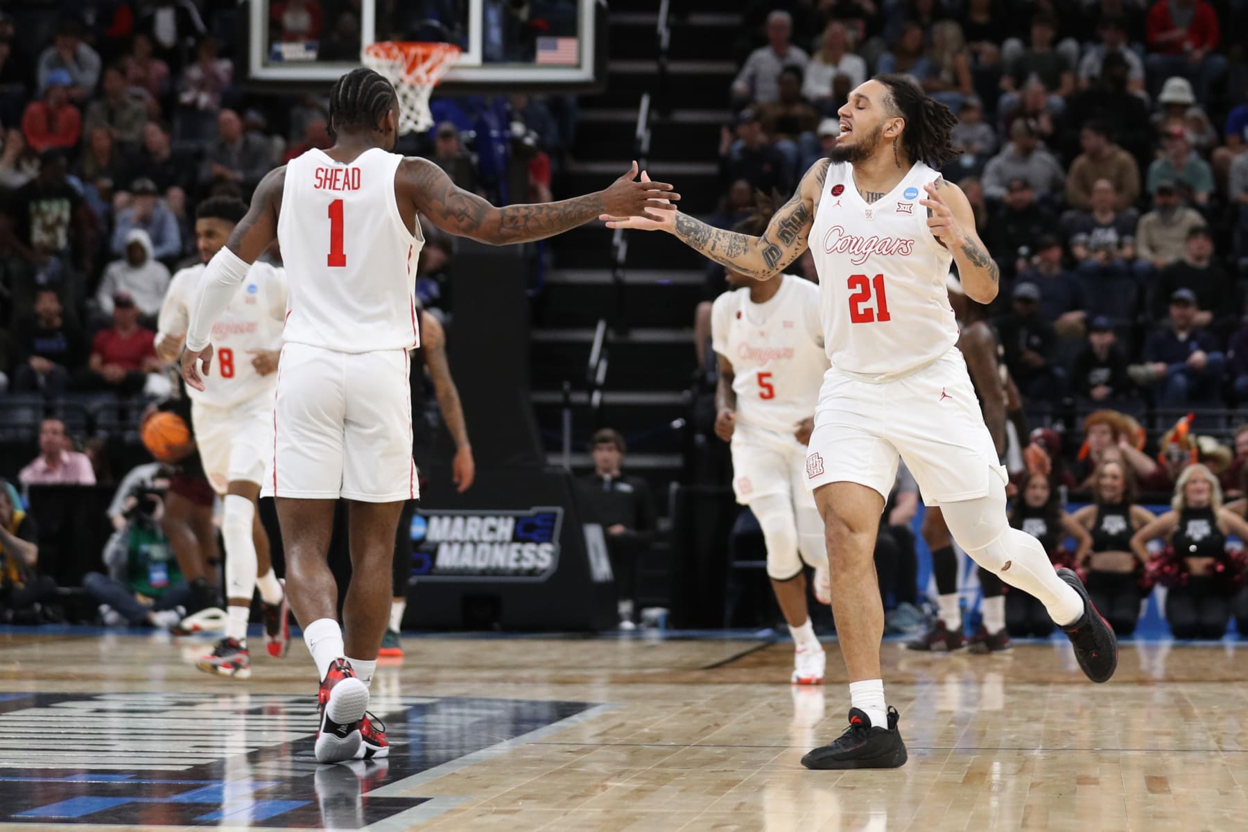 MEMPHIS, TENNESSEE - MARCH 24: Emanuel Sharp #21 and Jamal Shead #1 of the Houston Cougars high five during the first half against the Texas A&M Aggies in the second round of the NCAA Men's Basketball Tournament at FedExForum on March 24, 2024 in Memphis, Tennessee. (Photo by Justin Ford/Getty Images)