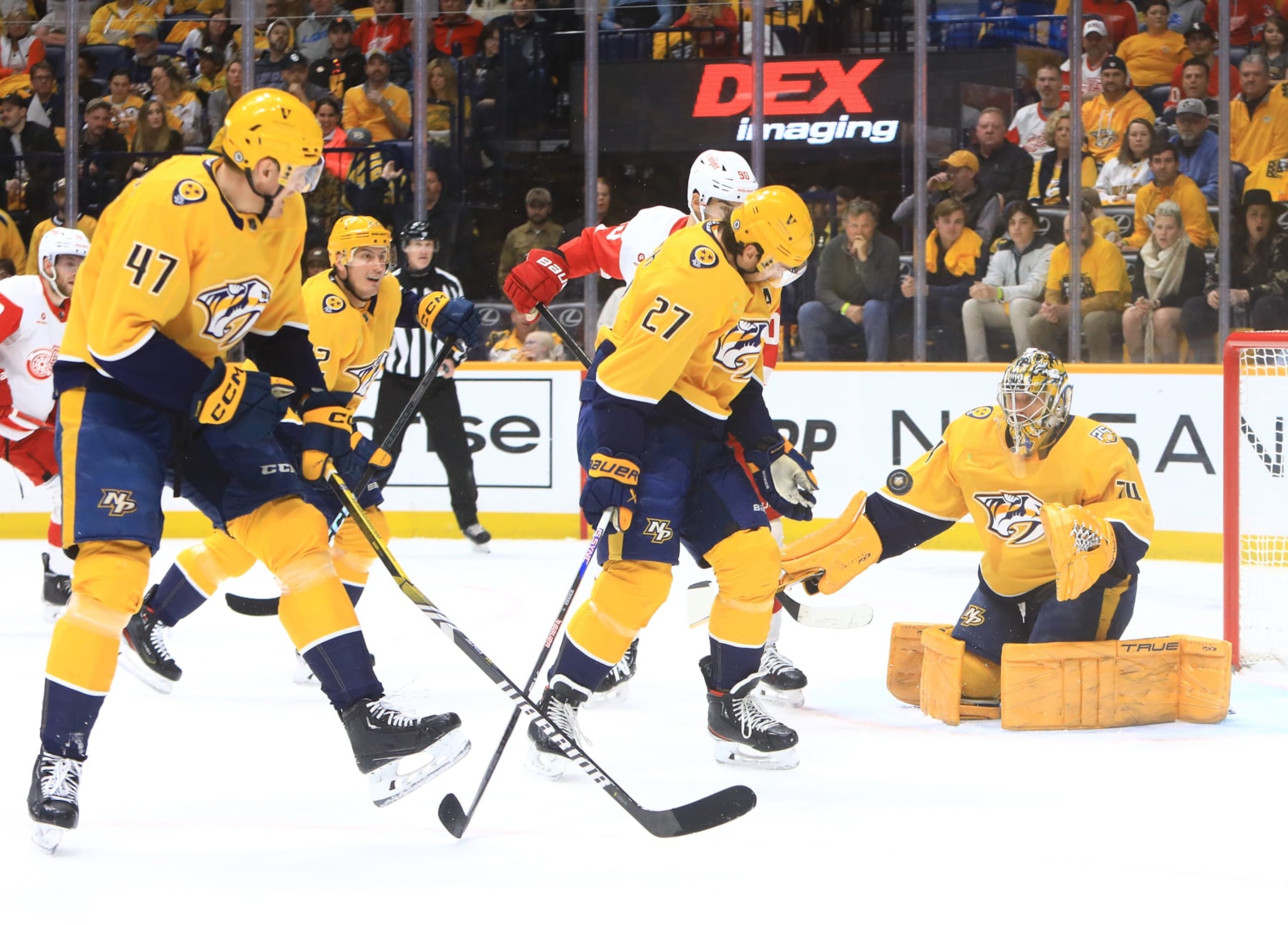 NASHVILLE, TN - MARCH 23: Nashville Predators right wing Michael McCarron (47) and defenseman Ryan McDonagh (27) defend in front of goalie Juuse Saros (74) during the NHL game between the Nashville Predators and Detroit Red Wings, held on March 23, 2024, at Bridgestone Arena in Nashville, Tennessee.  (Photo by Danny Murphy/Icon Sportswire via Getty Images)