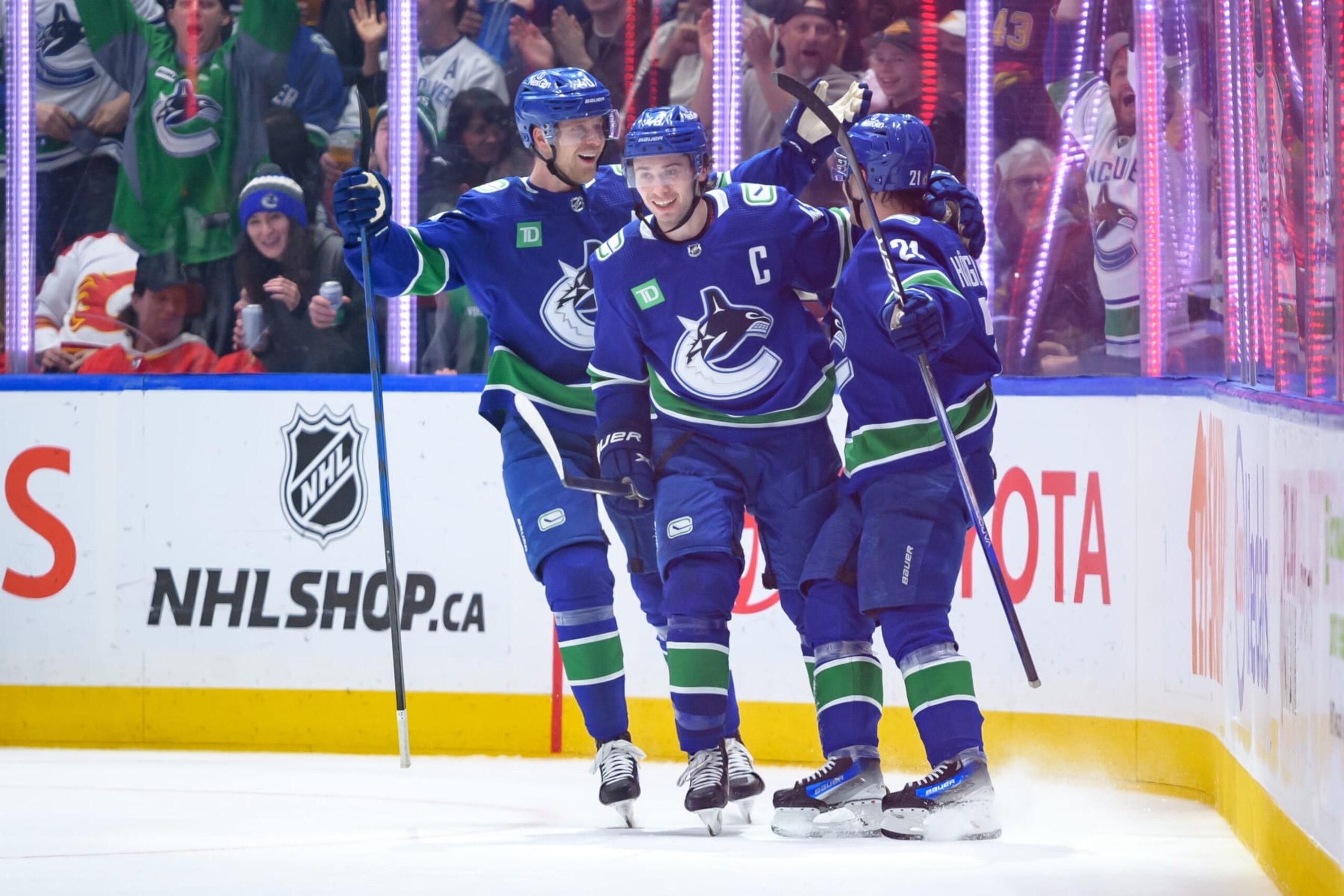 VANCOUVER, CANADA - MARCH 23: Nils Hoglander #21 of the Vancouver Canucks is congratulated after scoring a goal during the second period of their NHL game against the Calgary Flames at Rogers Arena on March 23, 2024 in Vancouver, British Columbia, Canada. (Photo by Derek Cain/Getty Images)
