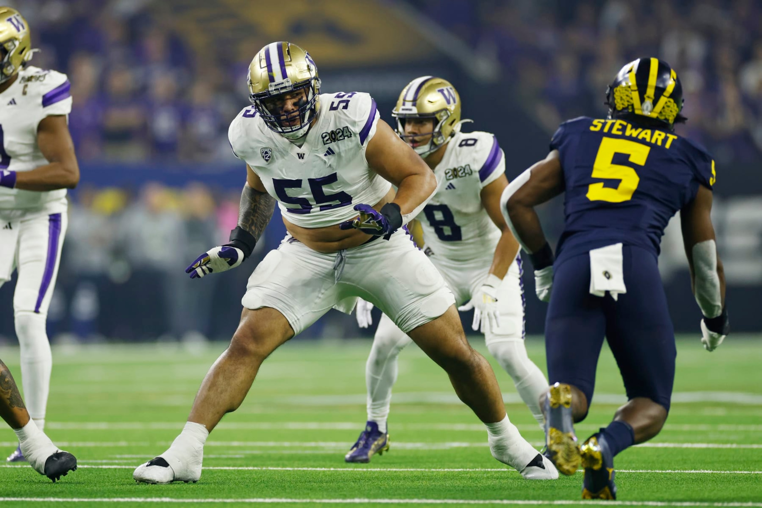 HOUSTON, TX - JANUARY 08: Washington Huskies offensive lineman Troy Fautanu (55) blocks during the CFP National Championship against the Michigan Wolverines on January 08, 2024 at NRG Stadium in Houston, Texas. (Photo by Joe Robbins/Icon Sportswire via Getty Images)