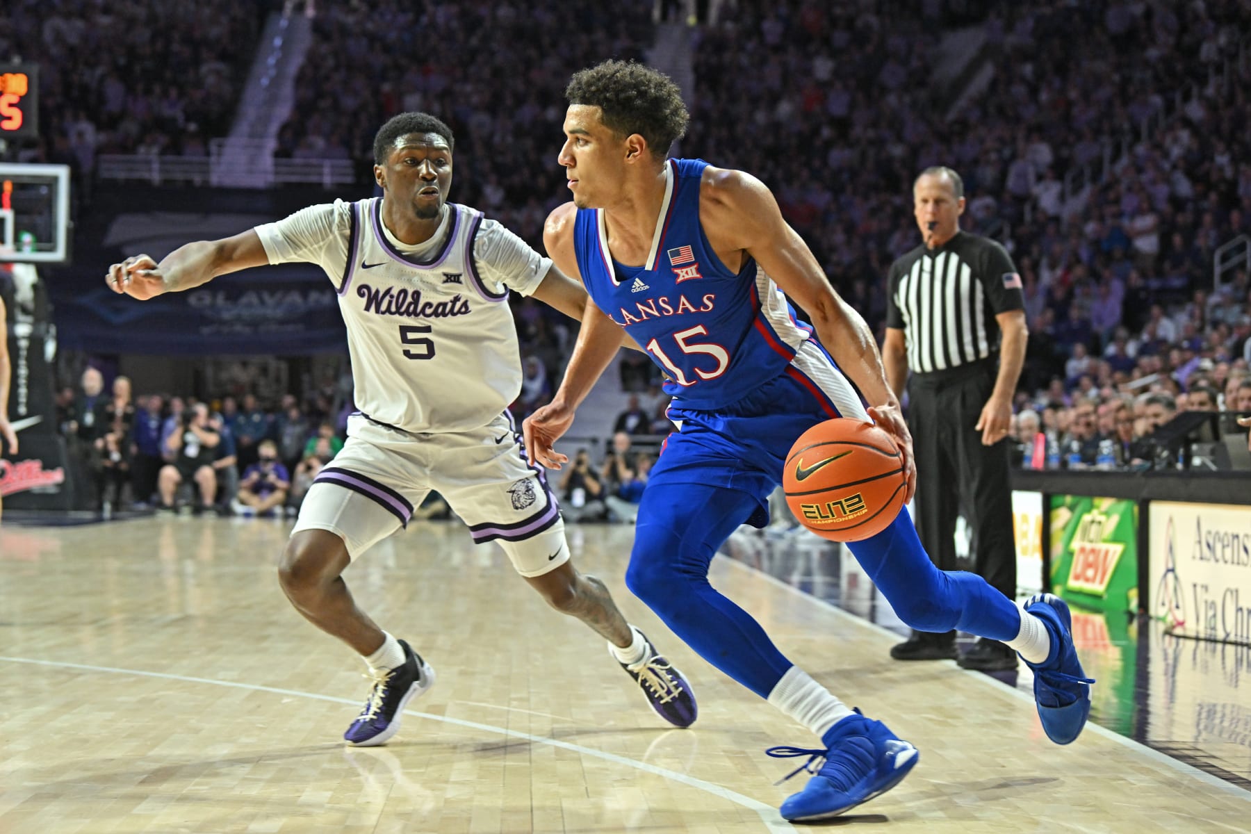 MANHATTAN, KS - FEBRUARY 05:  Kevin McCullar Jr. #15 of the Kansas Jayhawks dribbles the ball against pressure form Cam Carter #5 of the Kansas State Wildcats in the first half at Bramlage Coliseum on February 05, 2024 in Manhattan, Kansas.  (Photo by Peter G. Aiken/Getty Images)